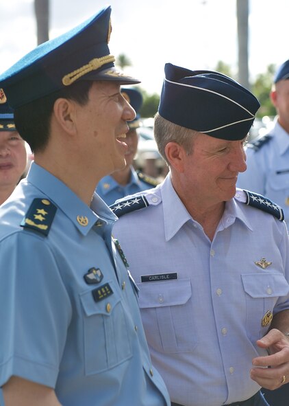 Gen. Hawk Carlisle, Pacific Air Forces commander (right), greets Lt. Gen. Huang Guoxian (left), commander Nanjing Military Regional Air Force Command, Sept. 23, 2014, Joint Base Pearl Harbor-Hickam, Hawaii.  Carlisle hosted Huang and a delegation of People's Liberation Army Air Force officers as part of a reciprocal visit key to building a strong military to military relationship between the U.S. and China. (U.S. Air Force photo by Tech. Sgt. James Stewart/Released)