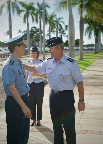 Gen. Hawk Carlisle, Pacific Air Forces commander (right), greets Lt. Gen. Huang Guoxian (left), commander Nanjing Military Regional Air Force Command, Sept. 23, 2014, Joint Base Pearl Harbor-Hickam, Hawaii.  Carlisle hosted Huang and a delegation of People's Liberation Army Air Force officers as part of a reciprocal visit key to building a strong military to military relationship between the U.S. and China. (U.S. Air Force photo by Tech. Sgt. James Stewart/Released)