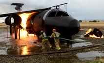 Beale firefighters combat a simulated aircraft fire during an aircraft emergency exercise Sept. 25, 2014, here. The scenario involved a simulated downed aircraft with multiple casualties and injured victims. (U.S. Air Force photo by John Schwab/Released)