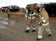 Beale firefighters rescue a simulated victim during an aircraft emergency exercise Sept. 25, 2014, here. The exercise was conducted to evaluate the installations emergency services procedures. (U.S. Air Force photo by John Schwab/Released)