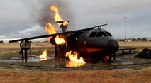 A simulated downed aircraft is set on fire during an aircraft emergency exercise Sept. 25, 2014, here. Beale firefighters routinely use the simulated aircraft to gain proficiency on aircraft fires. (U.S. Air Force photo by John Schwab/Released)