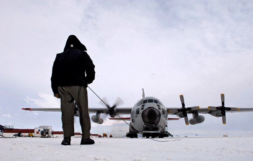 Chief Master Sgt. Bill Nolin conducts pre-flight checks on an LC-130 Hercules, Nov. 26, 2007, at the annual sea ice runway near McMurdo Station, Antarctica during Operation DEEP FREEZE. Airlift for Operation DEEP FREEZE involves active duty and Reserve C-17 Globemaster III support from Joint Base Lewis-McChord, Wa., LC-130 Hercules support from the New York Air National Guard, sealift support from the U.S. Coast Guard and Military Sealift Command, engineering and aviation services from U.S. Navy Space and Naval Warfare Systems Command, and cargo handling from the U.S. Navy. (U.S. Air Force photo by Tech. Sgt. Shane A. Cuomo/Released)