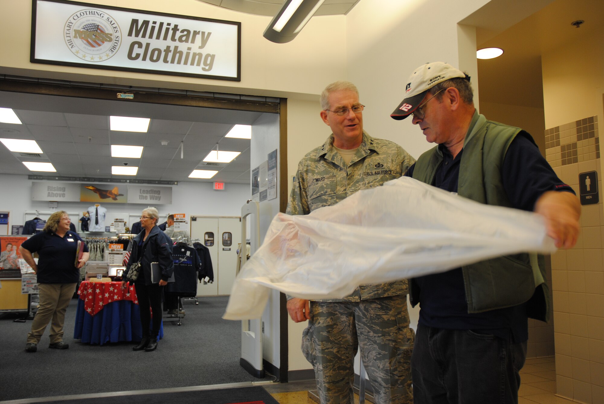 Maj. Gen. Joseph S. Ward Jr., deputy director of the Army & Air Force Exchange Service, gives a pat on the back and takes a moment to personally thank Exchange custodian Forrest Anderson for doing a great job in keeping the facilities clean and neat, during an official visit to the Exchange at Grand Forks Air Force Base, N.D., on Sept. 25, 2014.  Ward shook hands and talked to dozens of AAFES employees and patrons during his visit. AAFES employs approximately 41,000 civilian and military associates and provides retail stores, convenience stores, gas stations, restaurants, theaters, vending and other services on military installations in all 50 states, five U.S. territories and more than 30 countries. (U.S. Air Force photo/Staff Sgt. Luis Loza Gutierrez)
