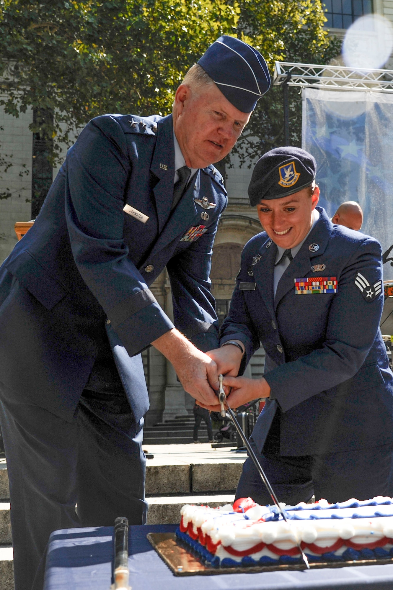 Maj. Gen. Verle Johnston, New York National Guard commander, cuts the birthday cake with Senior Airman Amanda Martino, 105th Security Forces Squadron member at Stewart Air National Guard Base, N.Y., during the Air Force's 67th birthday ceremony, Sept. 18, 2014, in New York. More than 50 Airmen from Joint Base McGuire-Dix-Lakehurst, N.J., and the New York Air National Guard travelled to New York to enjoy the Air Force’s 67th birthday in the ‘Big Apple.’ (U.S. Air Force photo by Airman 1st Class Tara A. Williamson/Released)