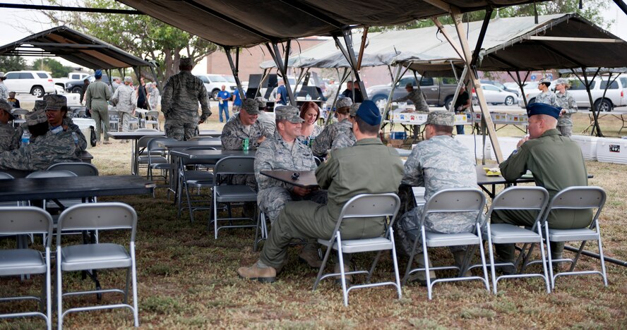 U.S. Air Force Airmen enjoy a barbecue held by base private organizations Sept. 11, 2014, at Dyess Air Force Base, Texas. On this day, a variety of events including a visit from fitness and motivational speaker, Ben Booker, a health fair and a barbecue were held here to support the physical pillar of Comprehensive Airmen Fitness. (U.S. Air Force photo by Airman 1st Class Alexander Guerrero/Released)