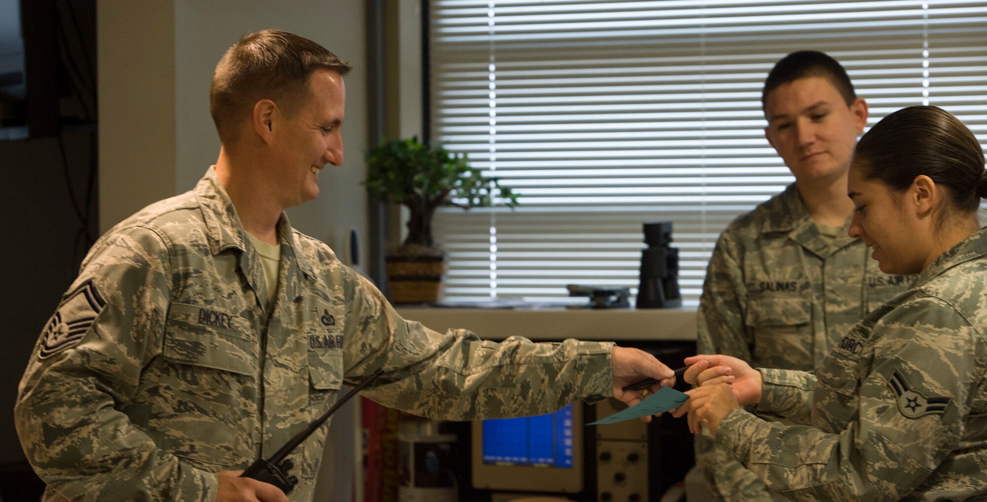 Senior Master Sgt. Robert T. Dickey, airfield manager with the 366th Operations Support Squadron at Mountain Home Air Force Base, Idaho, helps his Airmen in the office Sept. 18, 2014. Dickey has worked in airfield management his entire Air Force career. (U.S. Air Force photo by Airman 1st Class Jessica Smith/RELEASED)