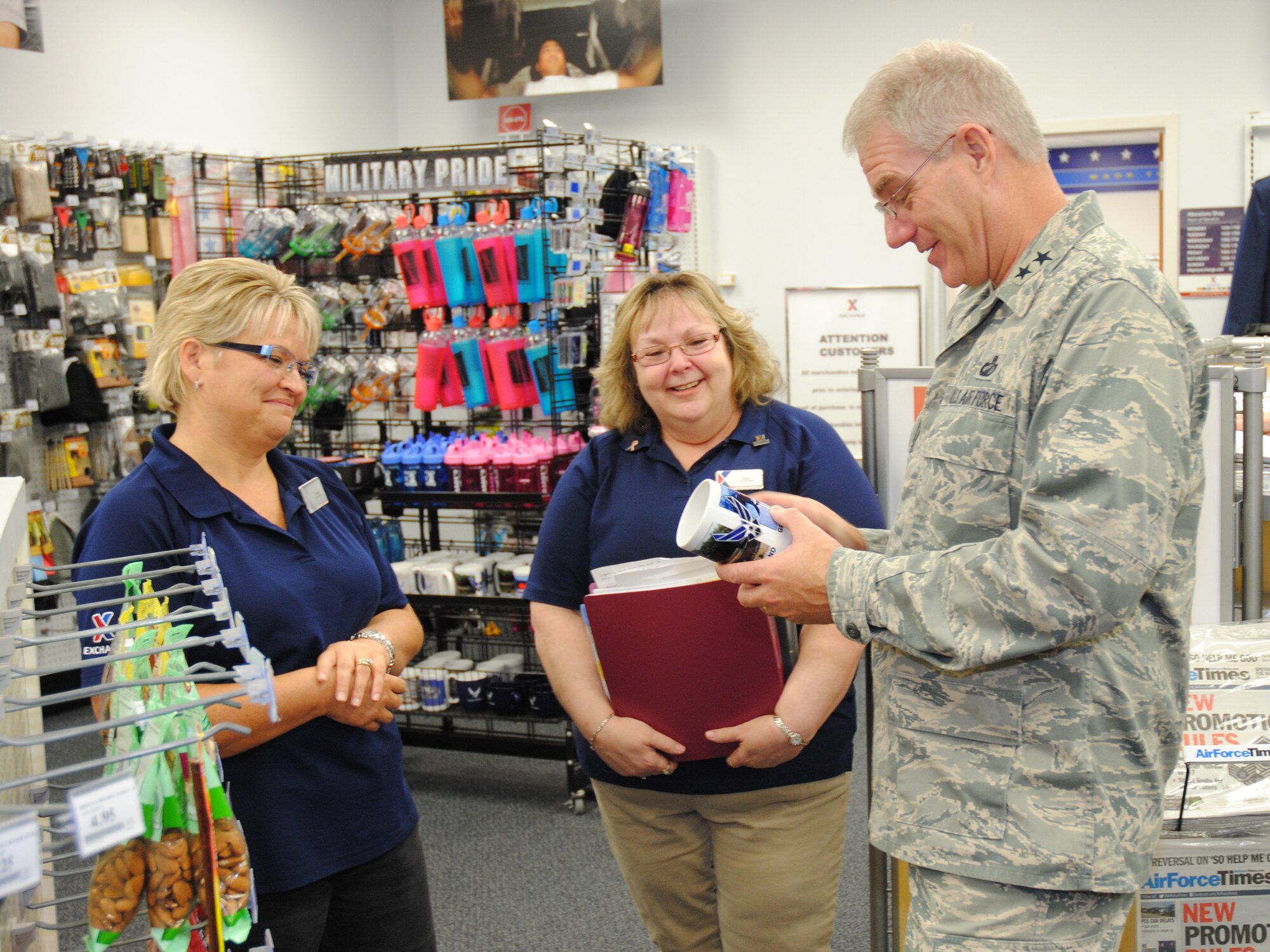 (From left to right) Sherry L. Chaffin, Grand Forks Air Force Base Military Clothing Sales Store manager and Pam Evenson, Grand Forks AFB Base Exchange assistant store manager, show Maj. Gen. Joseph S. Ward Jr., deputy director of the Army & Air Force Exchange Service, the store’s top selling souvenir; a coffee mug with a photo of the base marquee displaying -45 degrees Fahrenheit during Ward’s official visit to the Exchange on Grand Forks AFB, N.D., Sept. 25, 2014. Ward plans, trains, equips and leads AAFES to meet the needs of field commanders and their troops, whether deployed to forward locations, garrison or training centers. (U.S. Air Force photo/Staff Sgt. Luis Loza Gutierrez)
