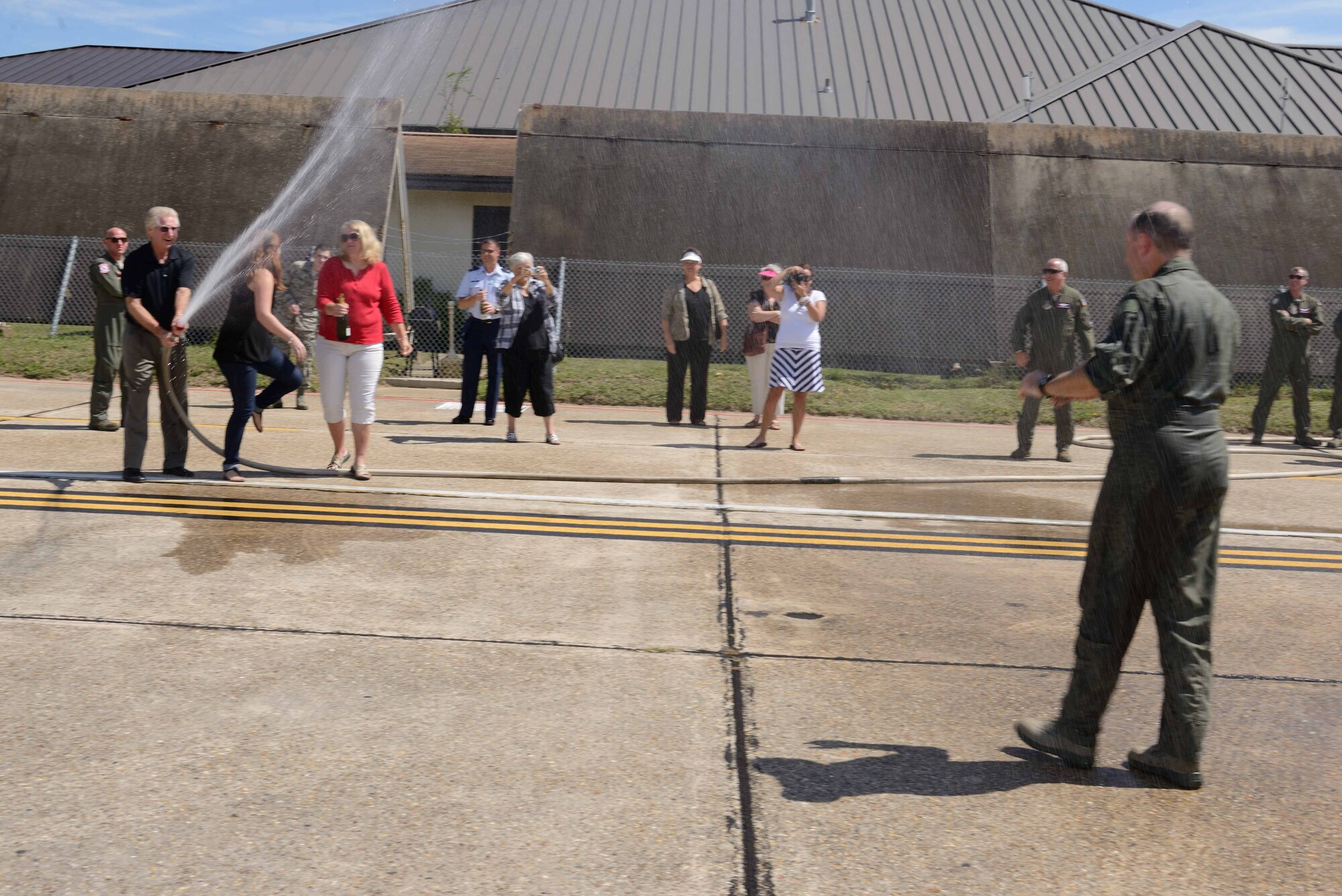 Lt. Col. Brian Freeman, 815th Airlift Squadron commander, gets hosed down after his final flight (or "fini" flight) with the squadron Sept. 25, 2014, at Keesler Air Force Base, Mississippi. Freeman is scheduled to leave command of the 815th AS and become the emergency preparedness liaison officer for the state of Mississippi, 1st Air Force, Oct. 1, 2014, as part of the National Security Education Program. (U.S. Air Force photo/Tech. Sgt. Ryan Labadens)