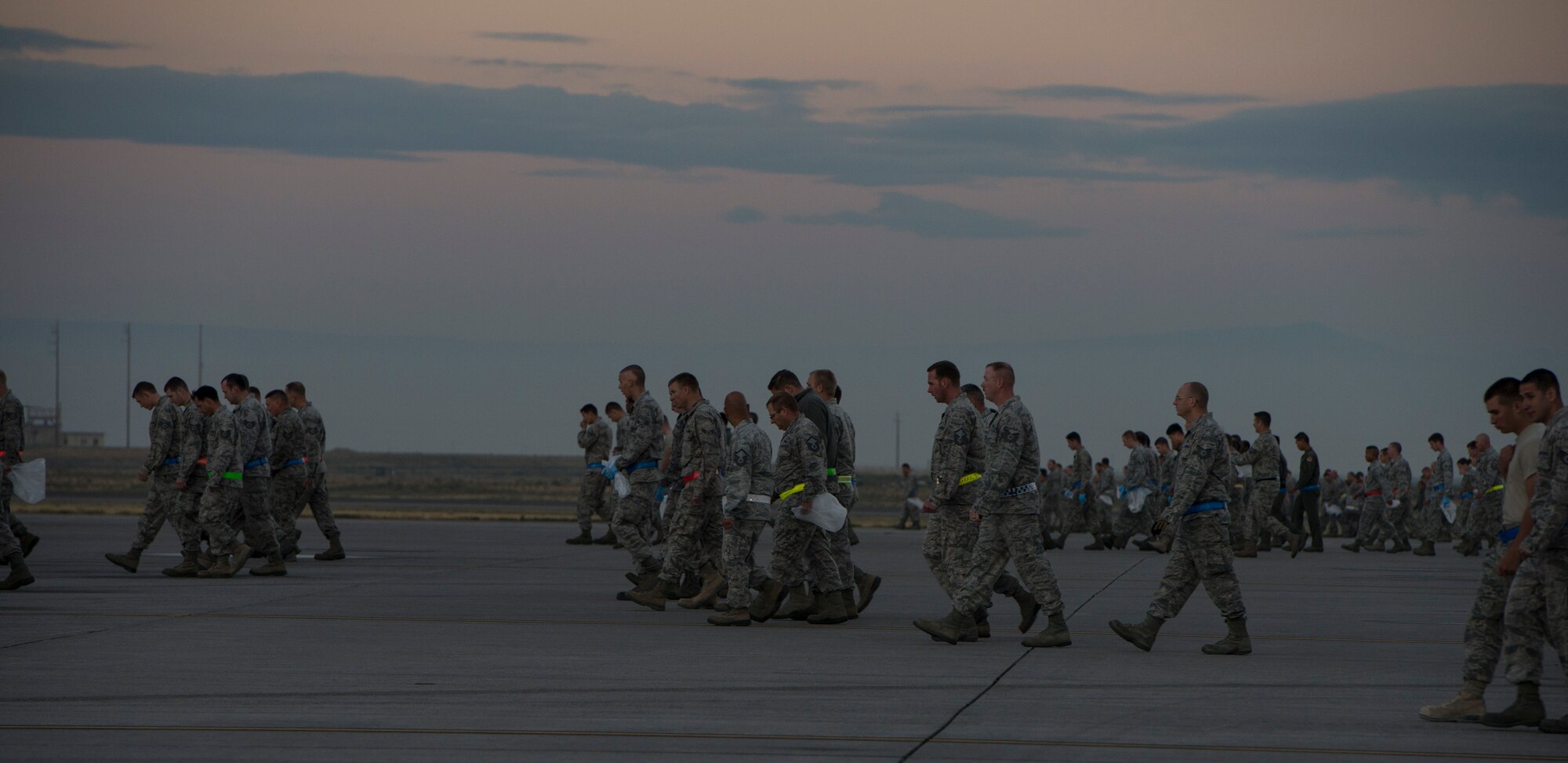 Service members from Mountain Home Air Force Base, Idaho, gather to pick up debris left behind from the open house in a wing-wide FOD walk on the flightline Sept. 22, 2014. Airfield management coordinated the event to get everyone involved in cleaning up the flightline. (U.S. Air Force photo by Airman 1st Class Jessica Smith/ RELEASED)