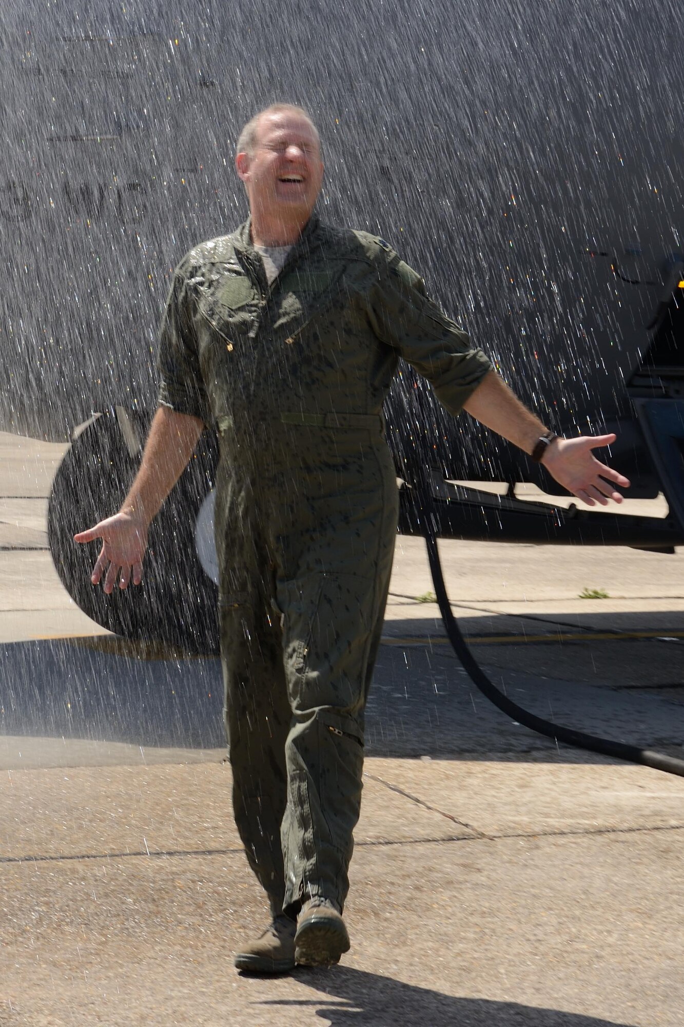 Lt. Col. Brian Freeman, 815th Airlift Squadron commander, gets hosed down after his final flight (or "fini" flight) with the squadron Sept. 25, 2014, at Keesler Air Force Base, Mississippi. Freeman is scheduled to leave command of the 815th AS and become the emergency preparedness liaison officer for the state of Mississippi, 1st Air Force, Oct. 1, 2014, as part of the National Security Education Program. (U.S. Air Force photo/Tech. Sgt. Ryan Labadens)