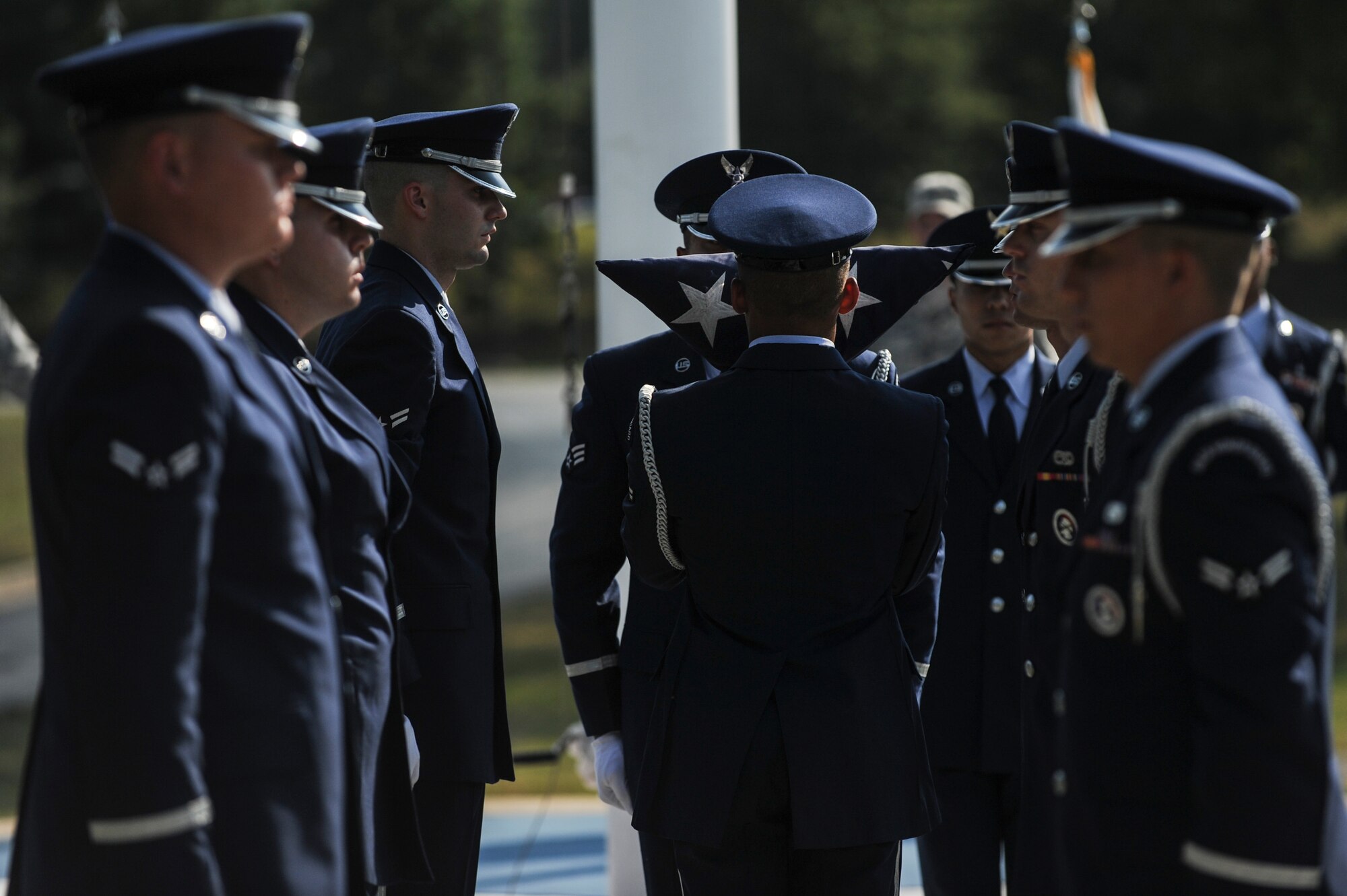 A member of base honor guard dresses the American Flag during the Prisoner of War/Missing in Action Recognition Day Retreat Ceremony Sept. 19, 2014, at Little Rock Air Force Base, Ark. The retreat ceremony was the conclusion of the base’s 24-hour remembrance run in honor of all POW/MIA personnel. (U.S. Air Force photo by Airman 1st Class Cliffton Dolezal)