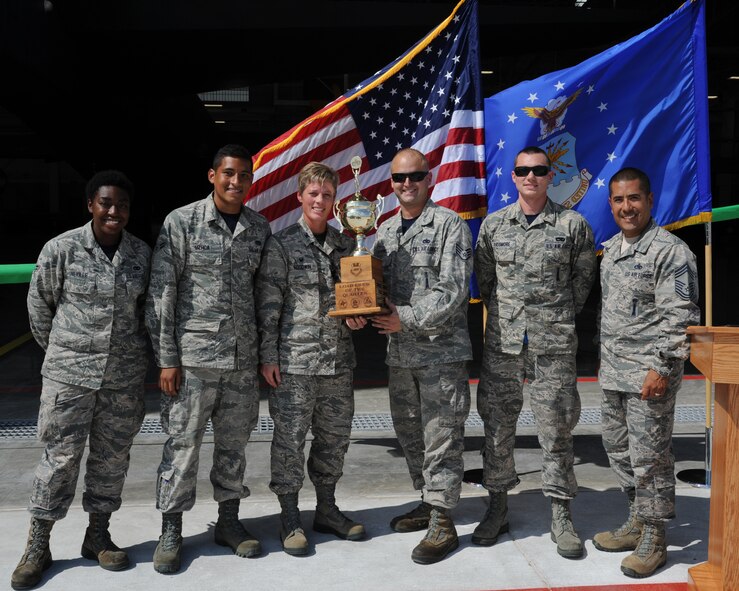 Airmen from the 20th Aircraft Maintenance Unit load crew pose with Col. Kristin Goodwin, 2nd Bomb Wing commander, as the winners of the quarterly weapons load competition on Barksdale Air Force Base, La., Sept. 19, 2014. In addition to the load competition, a ribbon cutting ceremony was held for the 2nd Maintenance Group Weapons Load Training Facility. (U.S. Air Force photo/Senior Airman Jannelle Dickey)
