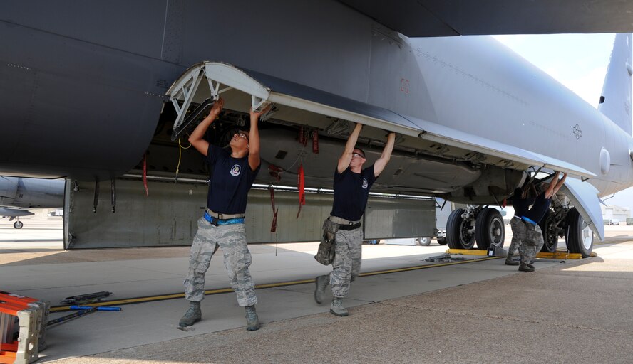 Load crew from the 20th Aircraft Maintenance Unit lower the bomb bay doors on a B-52H Stratofortress during a weapons load competition on Barksdale Air Force Base, La., Sept. 19, 2014.  The four-person crews from the 20th and 96th AMU uploaded a common strategic rotary launcher to determine which team is most efficient. (U.S. Air Force photo/Senior Airman Jannelle Dickey)