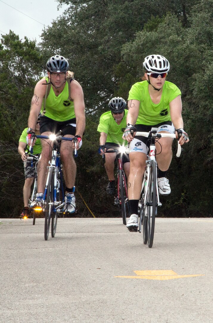 Ed Barnard, front left, Margaux Salas, front right, Todd Getz, rear left, and Jacob Minnick race down a hill of the 22-mile bike race portion of the annual Rambler 120 Competition Sept. 20 at Joint Base San Antonio Recreation Park at Canyon Lake. The Rambler 120, which is hosted by the 502nd Force Support Squadron, features four- and eight-person teams that engage in a friendly, but hard-fought, competition that challenges participants with a 22-mile bike race, 6-mile run, 2-mile raft race and a mystery event. Barnard, Salas, Getz, and Minnick are members of the U.S. Army Institute of Surgical Research-Air Force En route Care Research Center at JBSA-Fort Sam Houston. (U.S. Air Force photo by Johnny Saldivar)

