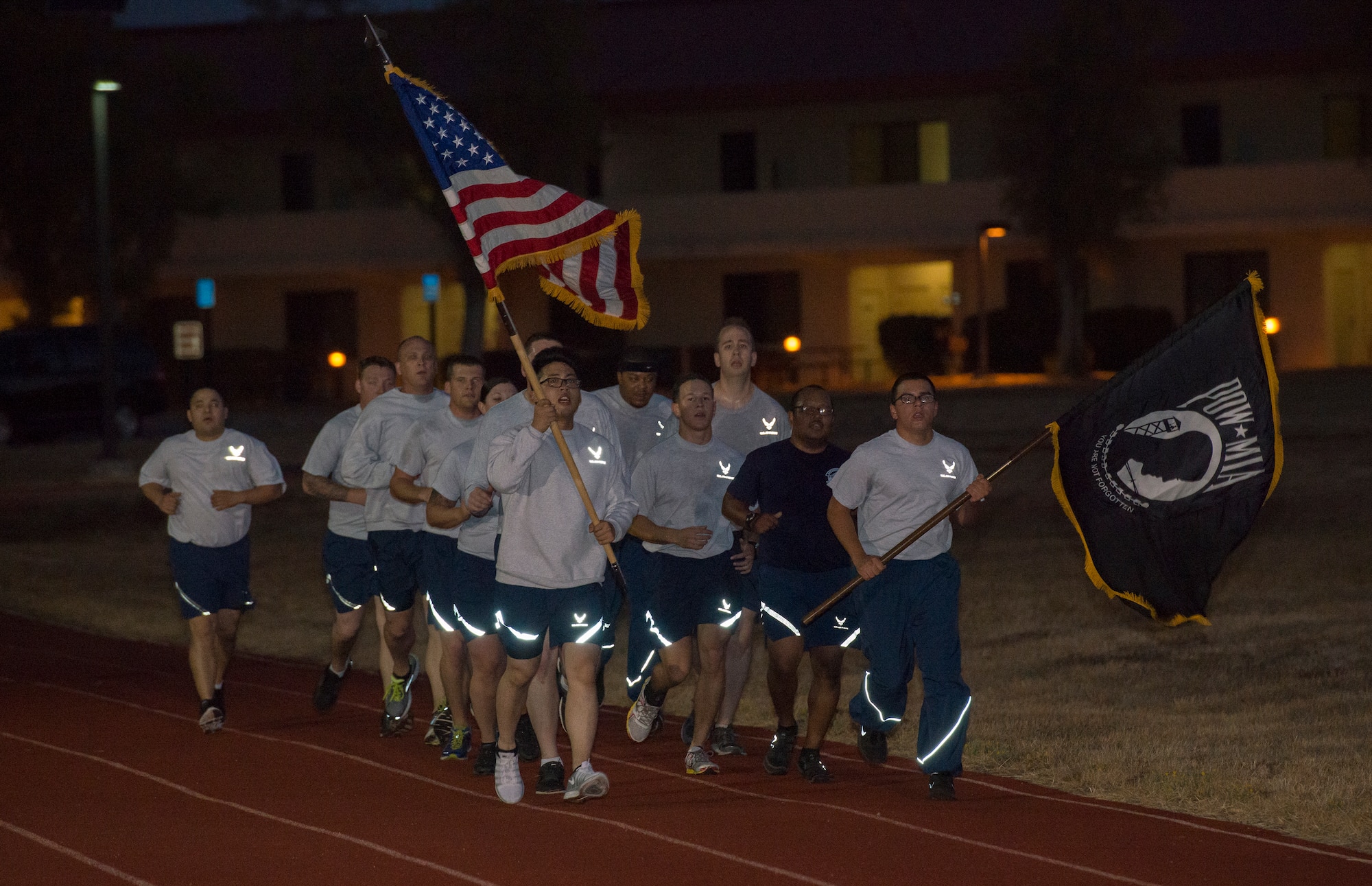 Team members from the 860th Aircraft Maintenance Squadron run to remember in the predawn hours at the Fitness Center at Travis Air Force Base Sept. 19. The 24 hour POW/MIA Relay Run is an annual event held in honor of those who spent years under duress in enemy prison camps, and the more than 83,00 American troops missing in action since World War II. (U.S. Air Force Photo/Heide Couch)