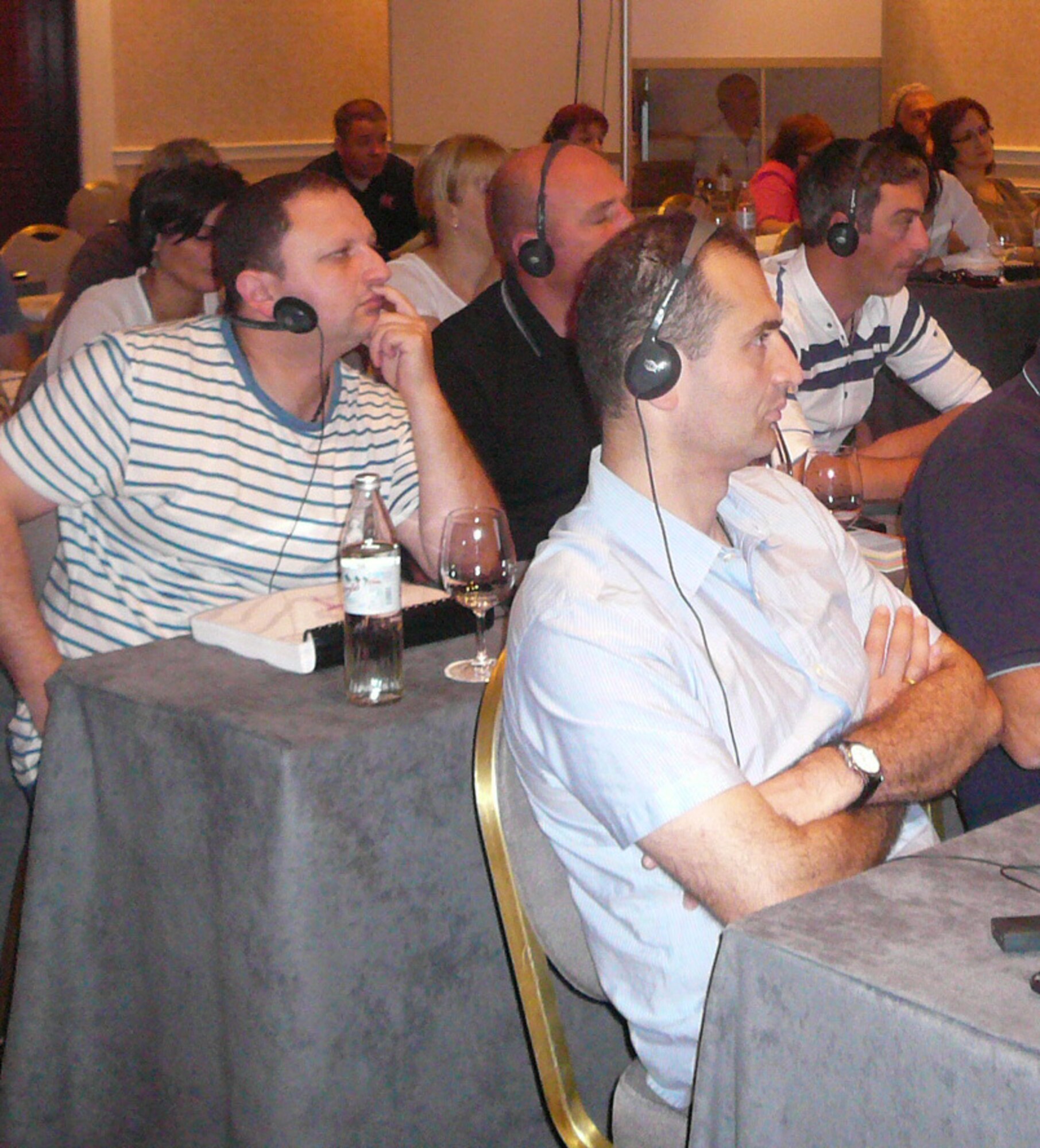 Physicians, infectious disease experts and hazmat response team members from the Republic of Georgia, listen to translators through headphones during a class taught by medical professionals from the 116th Medical Group (MDG), Georgia Air National Guard, during a four-day course in the Republic of Georgia, Sept. 9, 2014. Eight members from the 116th MDG, based out of Robins Air Force Base, Ga., were invited to the Republic of Georgia by the U.S. European Command to teach physicians, infectious disease experts and hazmat response teams about treating patients in a chemical, biological, radiological, nuclear and high-yield explosive environment. The trip is one of more than 10 engagements in 2014 by Georgia National Guardsmen in what has been an ongoing 19-year relationship with the country as a part of the Department of State's Partnership for Peace program. (U.S. Air National Guard photo by Chief Master Sgt. Cynthia Haines/Released)