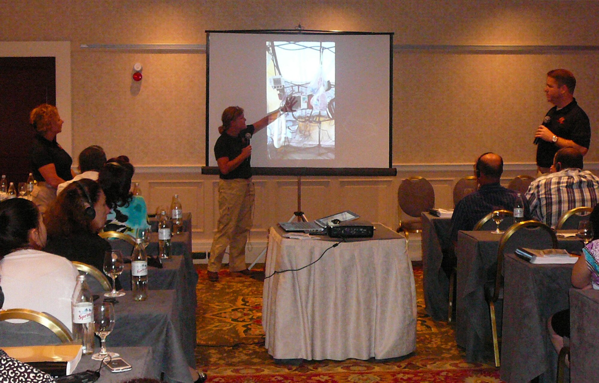 U.S. Air Force Col. Muriel Herman, center, commander of the 116th Medical Group (MDG), Georgia Air National Guard, shows a photo from a Homeland Response Force exercise while teaching a class in the Republic of Georgia, Sept. 9, 2014. Herman and eight members from the 116th MDG, based out of Robins Air Force Base, Ga., were invited to the Republic of Georgia by the U.S. European Command to teach physicians, infectious disease experts and hazmat response teams about treating patients in a chemical, biological, radiological, nuclear and high-yield explosive environment. The trip is one of more than 10 engagements in 2014 by Georgia National Guardsmen in what has been an ongoing 19-year relationship with the country as a part of the Department of State's Partnership for Peace program. (U.S. Air National Guard photo by Chief Master Sgt. Cynthia Haines/Released)

