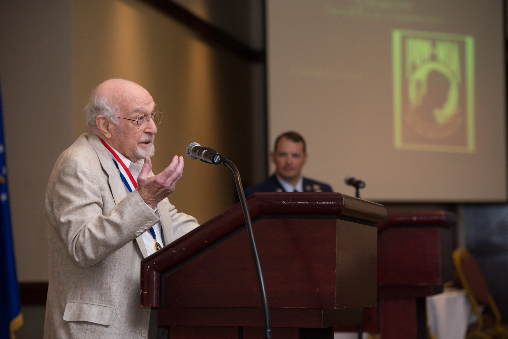 Robert Tharratt, former World War II prisoner of war, speaks to Airmen at Travis Air Force Base during a POW/MIA memorial event Sept. 19. Tharratt described in detail the day the B-17 Flying Fortress he was serving as ball-turret gunner, was shot down over Nuremberg, Germany. Ultimately, he spent more than seven months as a POW, which included a devastating 600-mile forced march. Tharratt, who helped save the life of an aircrew member before baling out, was awarded the Distinguished Flying Cross 55 years after the war. (U.S. Air Force photo/Ken Wright)