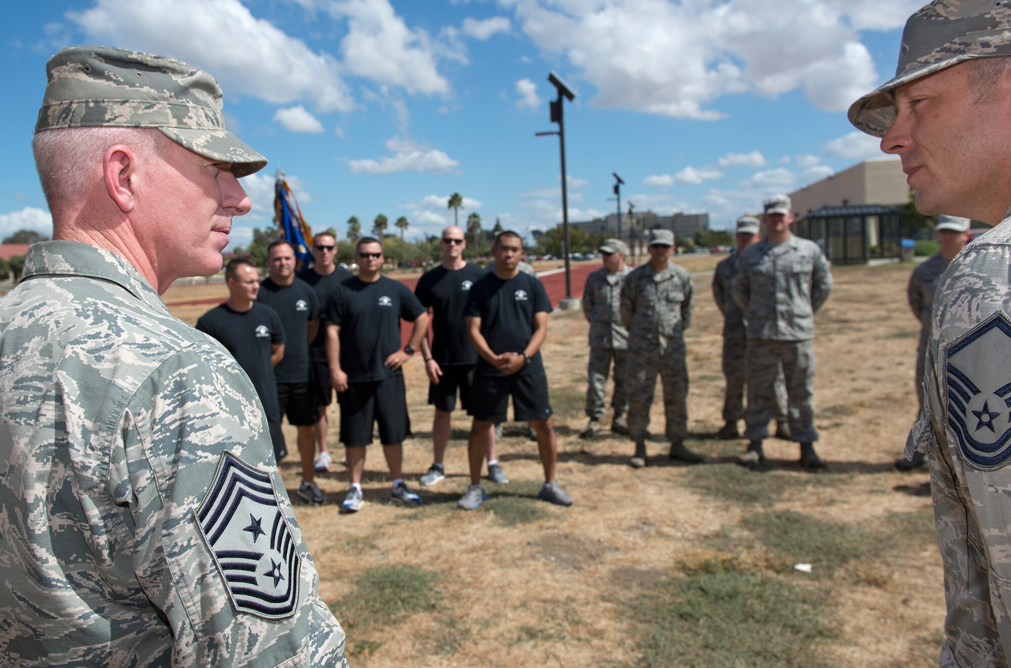 Master Sgt. Matthew Cannon, 60th Aerial Port Squadron flight chief and Chief Master Sgt.  Alan Boling, 60th Air Mobility Wing command chief, rally the troops before the kick off of the 24 hour POW/MIA Relay Run on the Red Track at the Fitness Center on Travis Air Force Base Sept. 18. The relay run serves the purpose of honoring and remembering those who were prisoners of war and those who are missing in action since World War II.   (U.S. Air Force Photo/Heide Couch)