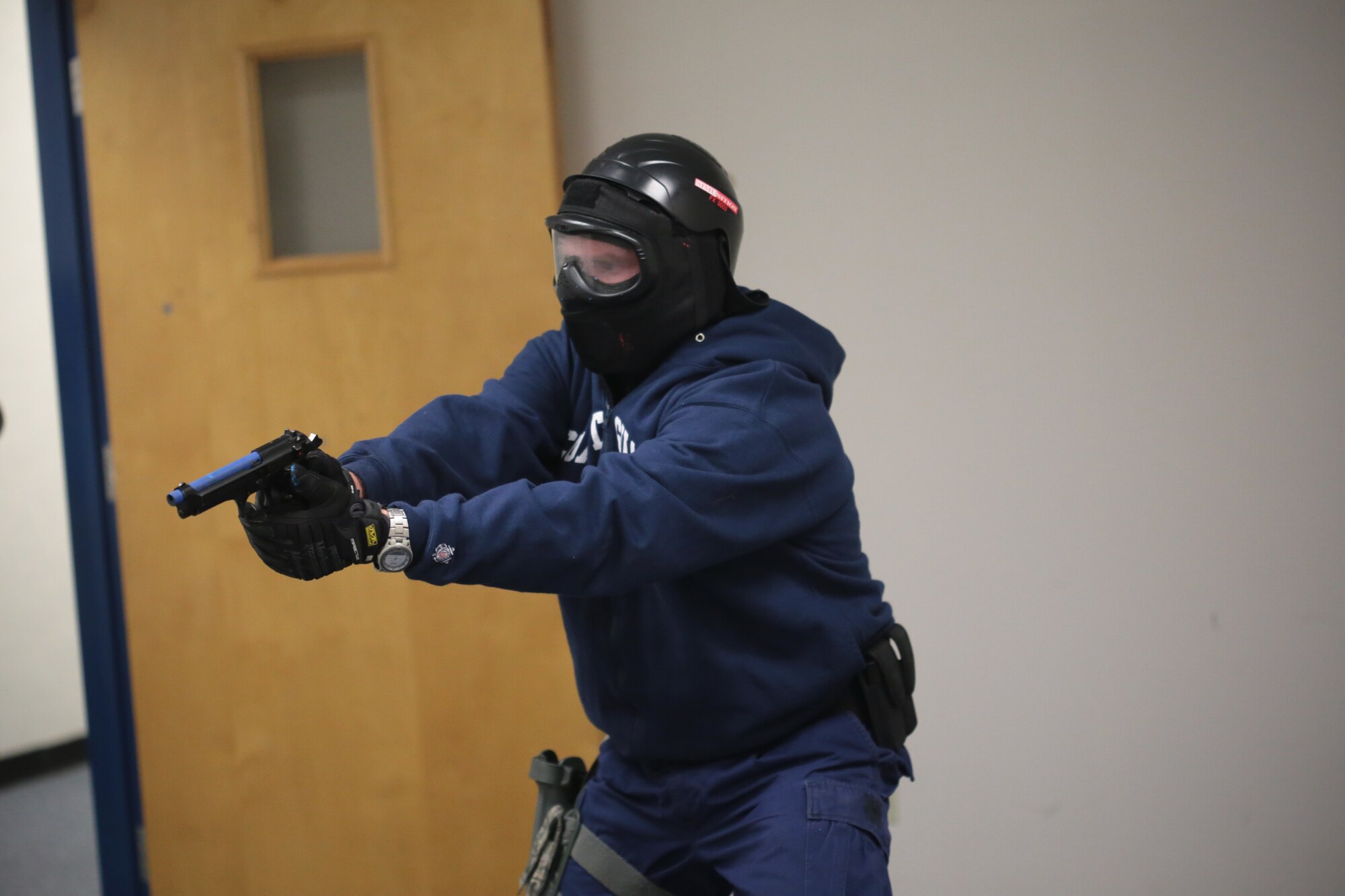 A picture of U.S. Coast Guard Petty Officer 1st Class Seth Tucker clearing a room during active shooter training.