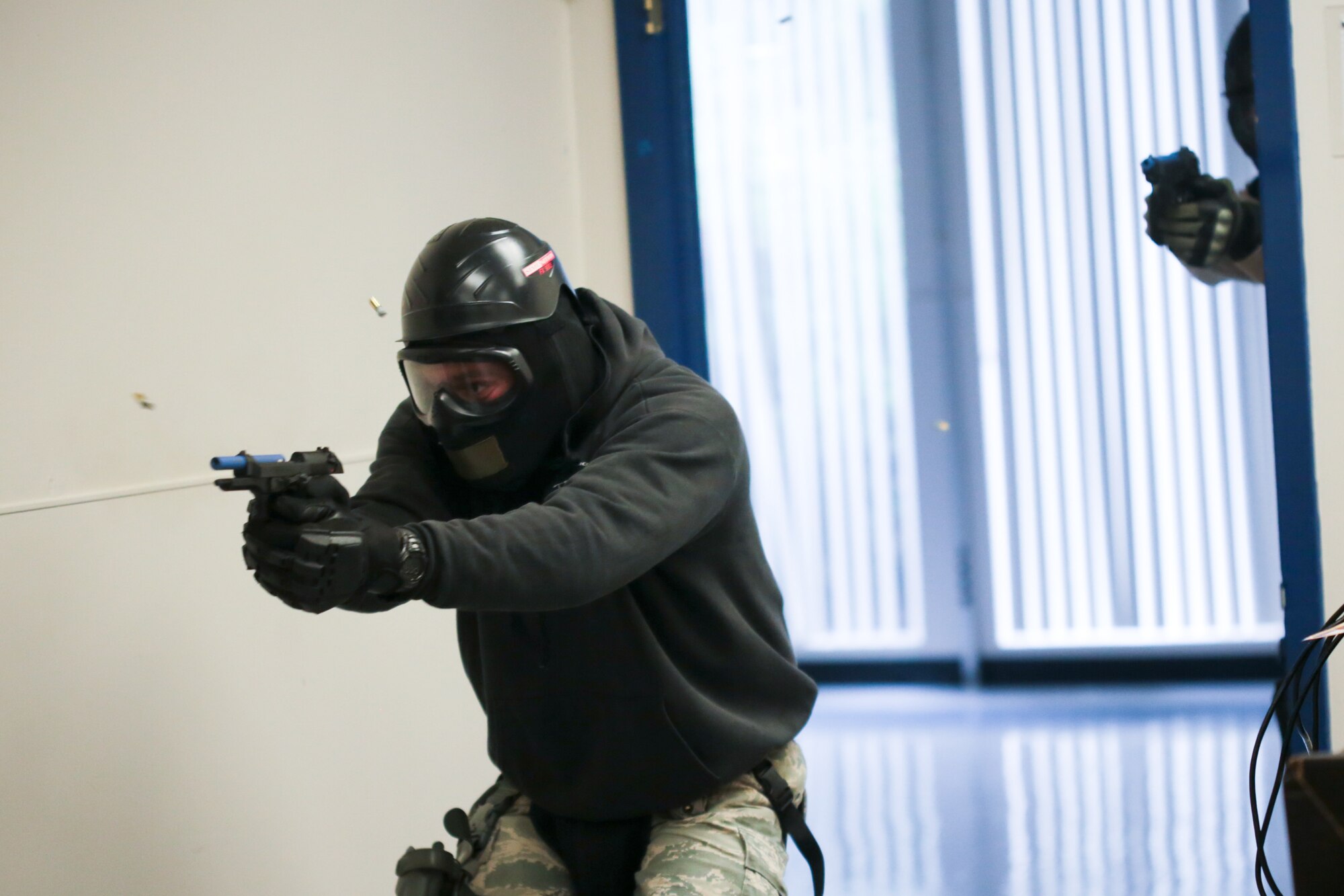 A picture of U.S. Air Force Master Sgt. Jeffrey Tafrow from New Jersey Air National Guard's 177th Security Forces Squadron entering a room and engaging a simulated shooter.