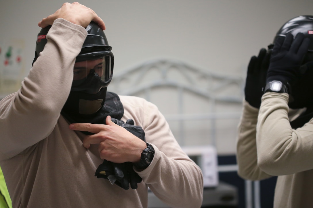 U.S. Air Force Airmen from New Jersey Air National Guard's 177th Security Forces Squadron put on protective gear prior to a scenario during active shooter training at Atlantic Cape Community College in Mays Landing, N.J. on Sept. 24, 2014. New Jersey Air National Guard, U.S. Coast Guard, and local law enforcement officers were taught Active Shooter Level I training by an Air Force Reserve mobile training team from the 610th Security Forces Squadron, which is based out of Naval Air Station Joint Reserve Base Fort Worth. (U.S. Air National Guard photo by Tech. Sgt. Matt Hecht/Released)