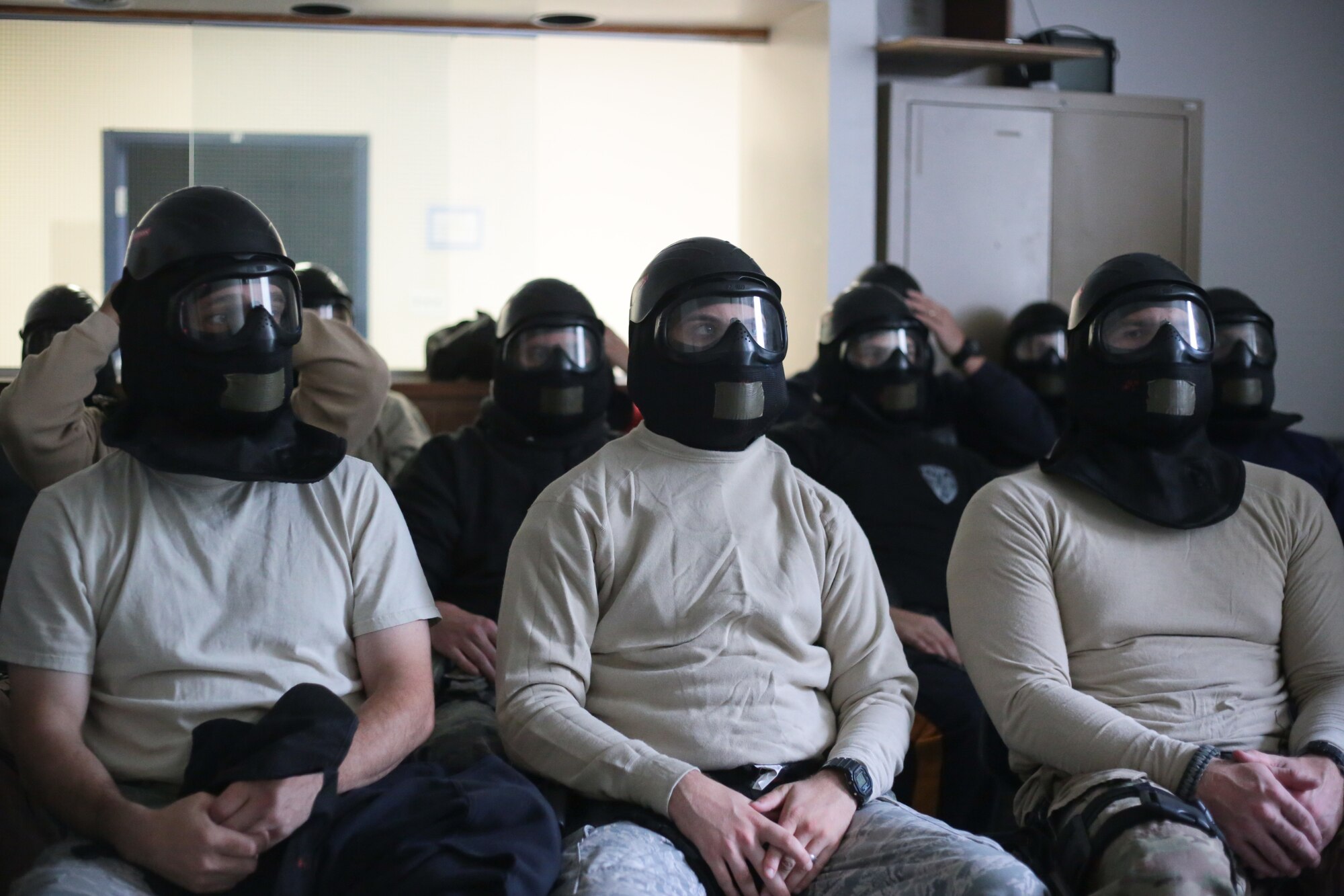 A picture of New Jersey Air National Guard, U.S. Coast Guard, and local law enforcement officers wearing protective gear during active shooter training.
