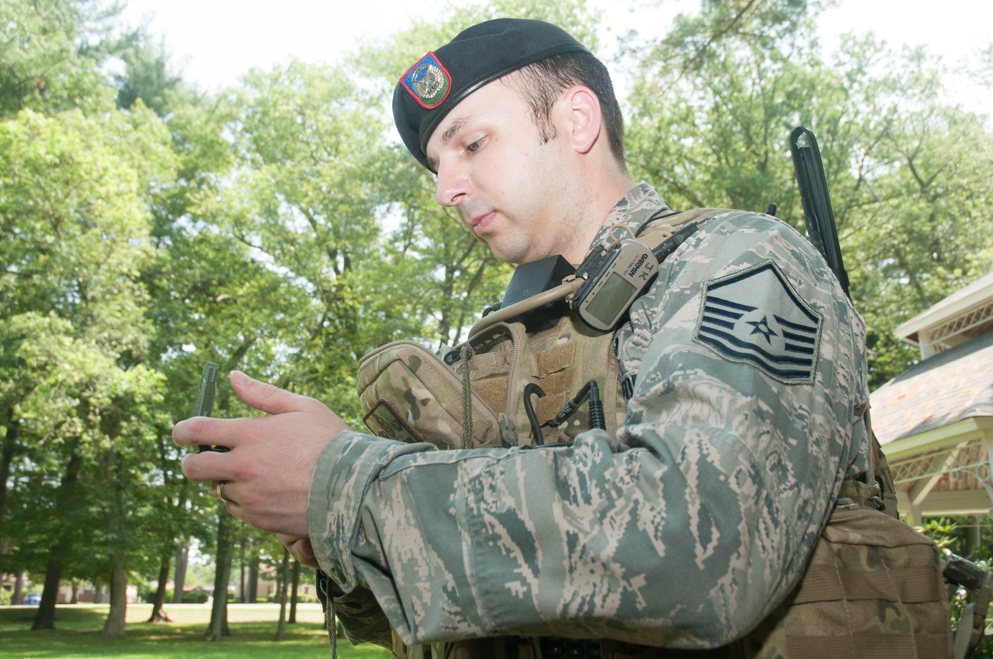 U.S. Air Force Master Sgt. Jeffrey Kennedy, a tactical air control party Airman, demonstrates the use of his compass and radio equipment at Hanscom AFB, Mass., July 20, 2014. Kennedy serves as the TACP-Modernization program office superintendent. TAC-M, a Life Cycle Management Center unit, is responsible for acquiring and fielding mounted and dismounted TACP equipment. (U.S. Air Force photo by Mark Herlihy)