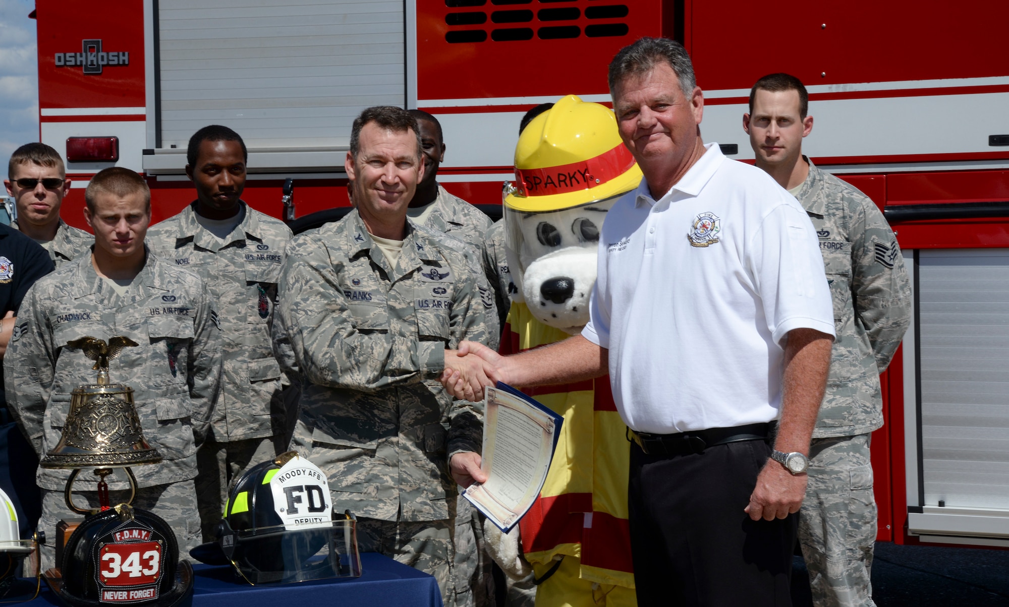 U.S. Air Force Col. Chad Franks, 23d Wing commander, and Steven Seward, 23d Civil Engineer Squadron fire chief pose for a photo after signing a Fire Prevention Proclamation Sept. 22, 2014, at Moody Air Force Base, Ga. Fire Prevention Week spans from October 5-11 and 23d CES workers are scheduled to visit the Child Development Center, Youth Programs, and work centers on base to provide fire prevention education during that time.  (U.S. Air Force photo by Senior Airman Sandra Marrero/Released)