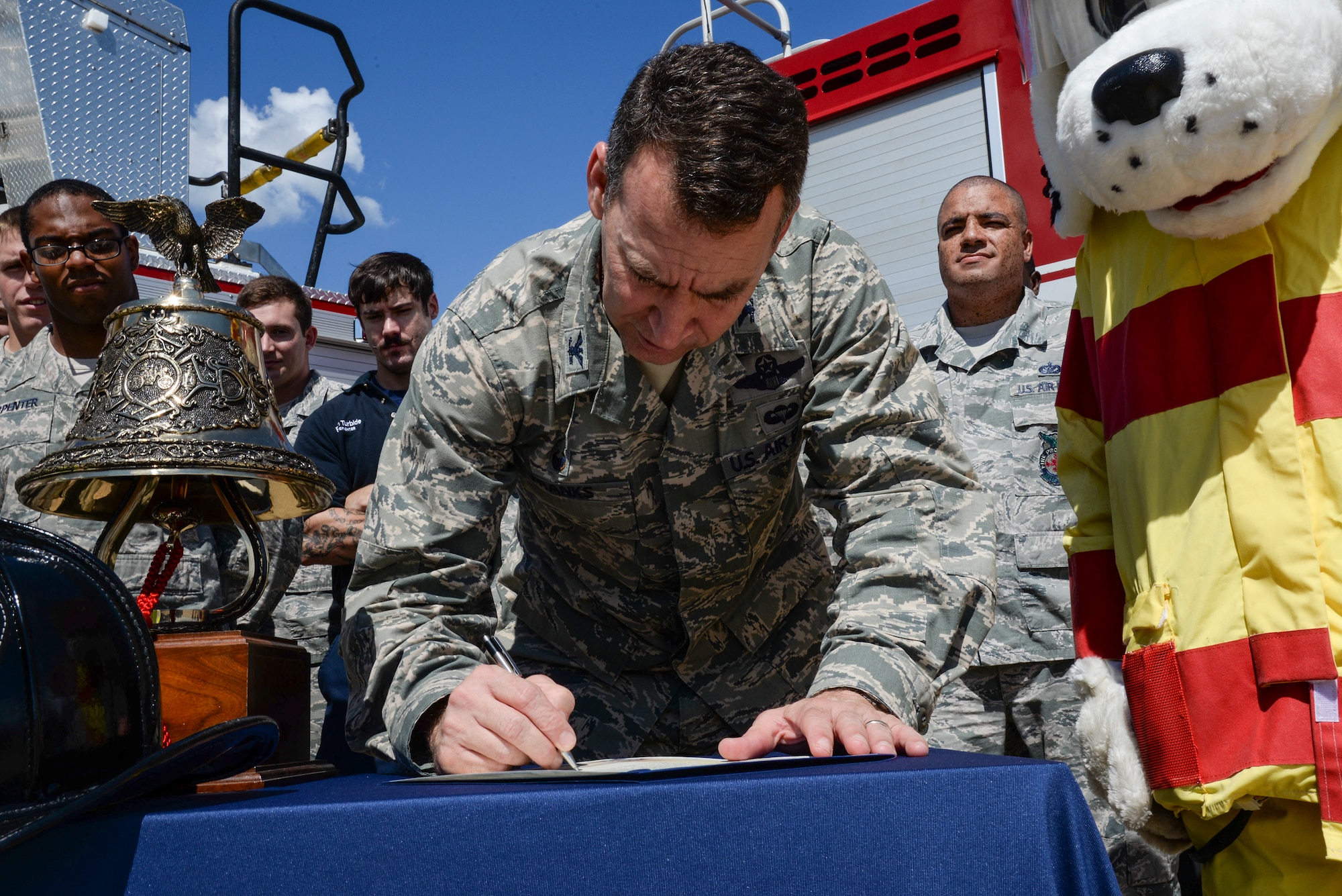 U.S. Air Force Col. Chad Franks, 23d Wing commander, signs a Fire Prevention Proclamation Sept. 22, 2014, at Moody Air Force Base, Ga. The proclamation states the importance of fire safety and names Franks as honorary fire chief during Fire Prevention Week. (U.S. Air Force photo by Senior Airman Sandra Marrero/Released)
