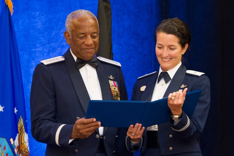 Brig. Gen. Nina Armagno, 45th Space Wing commander, presents Ret. Gen. Lloyd “Fig” Newton, guest speaker, and Air Force education and training command and former commander, with a gift for the Tuskegee Airmen incorporate chapter, in Newton’s name, Sept. 19, 2014, during the Air Force birthday celebration, Melbourne, Fla. (U.S. Air Force photo/Matthew Jurgens) (Released)