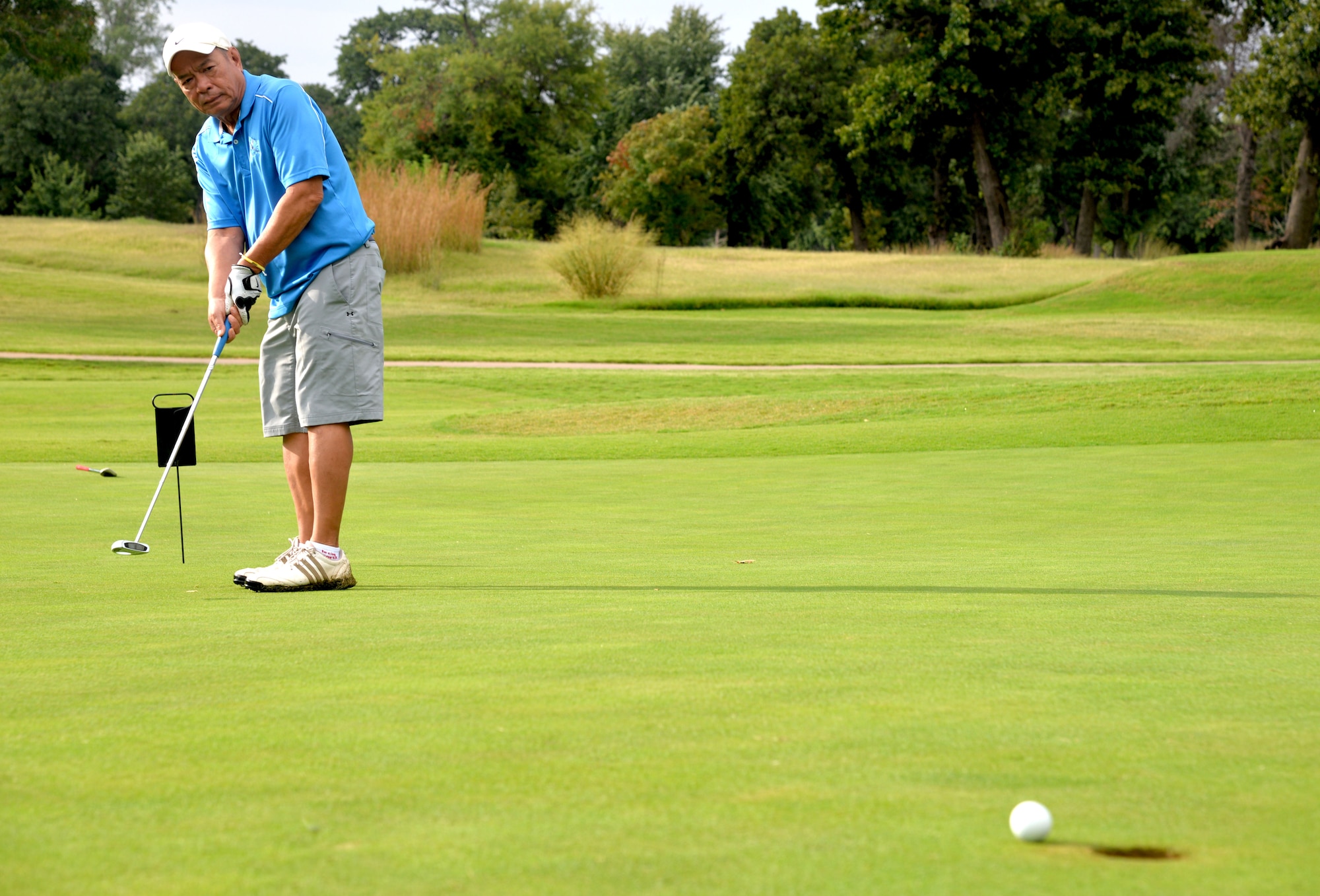 Troy Parnomchol, a Vance aircraft mechanic, makes a putt during a golf tournament at the Oakwood Country Club in Enid, Okla. The yearly tournament creates an opportunity for community leaders to meet base personnel in a social environment. (U.S. Air Force photo/Senior Airman Frank Casciotta)