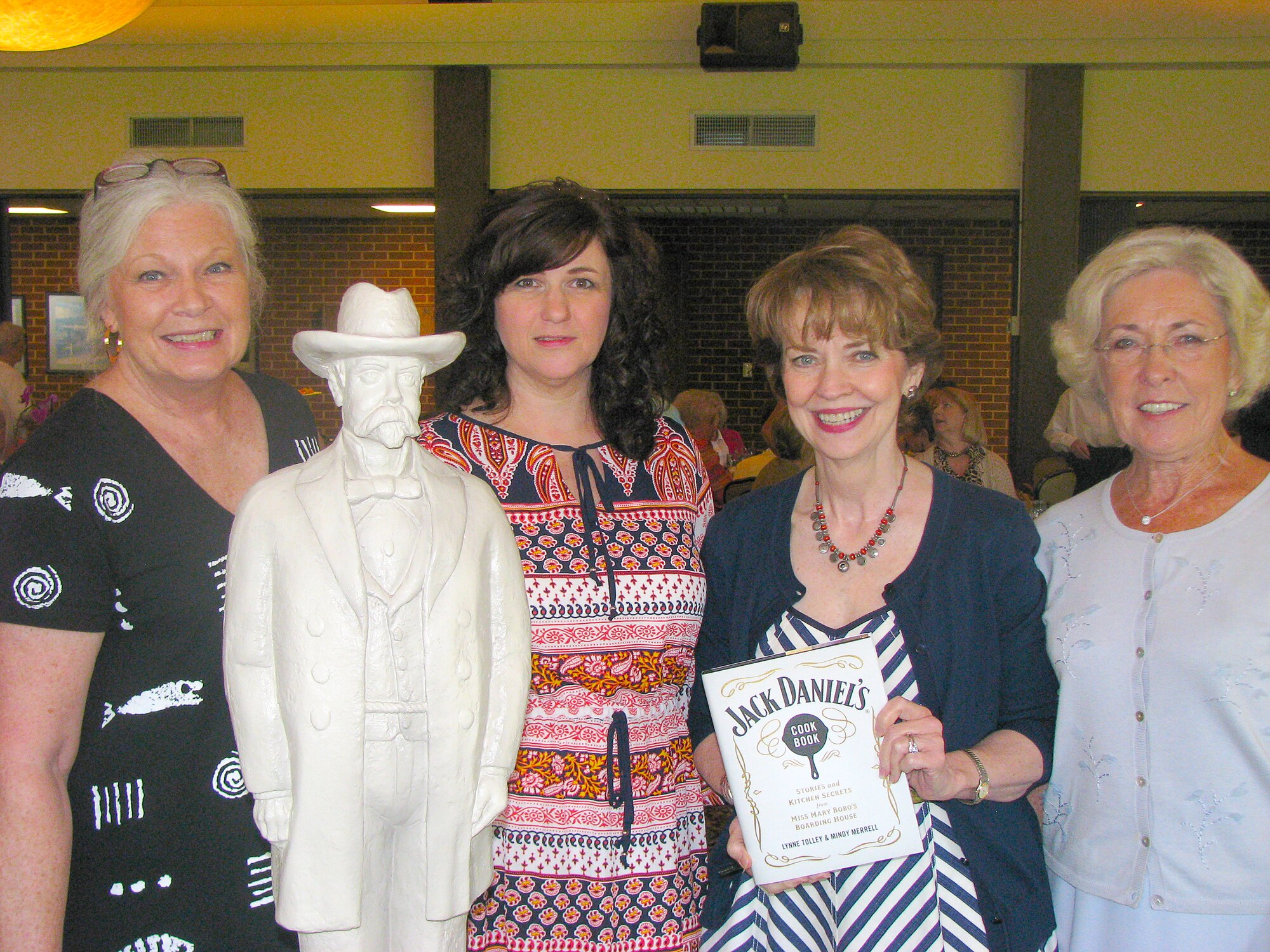 Arnold Engineering Development Complex (AEDC) Woman’s Club (AWC) member Jo Todd (far left) and Theresa Toth (second from left), the AWC honorary president and base commander’s wife, share a moment with guest speaker Lynne Tolley (third from left) and guest Emily Bedford at the Sept. 2 AWC meeting at the Arnold Lakeside Center. Meeting attendees were able to have Jack Daniel’s Cookbooks signed by Tolley. She is the great, great-niece of Jack Daniel and the proprietress of Miss Mary Bobo’s Boarding House and Restaurant in Lynchburg. (Photo provided)