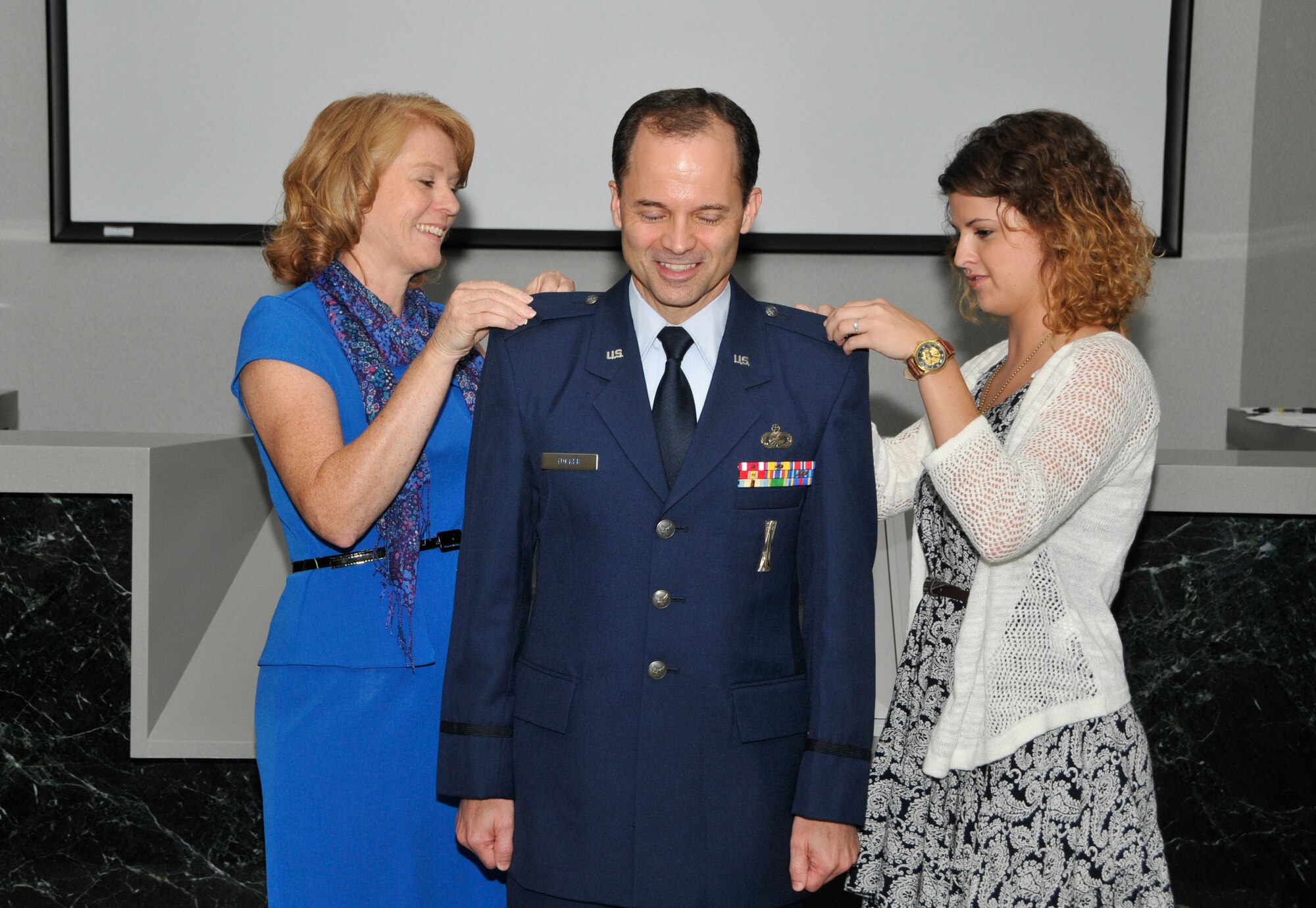 During a recent promotion ceremony at Arnold Engineering Development Complex (AEDC), Lt. Col. Ed Tucker (center) was promoted to the rank of colonel in the U.S. Air Force Reserve. Tucker’s wife Pam and daughter Kristina are shown here pinning on his new rank. Also participating in the ceremony was Tucker’s sons Bradley and Brandon, and Bradley's wife Amber. Col. Tucker is the senior reservist for the 96th Test Wing at Eglin AFB. Tucker also serves as chief of the AEDC High Speed Systems Test Technology Branch. (Photo by Jacqueline Cowan)