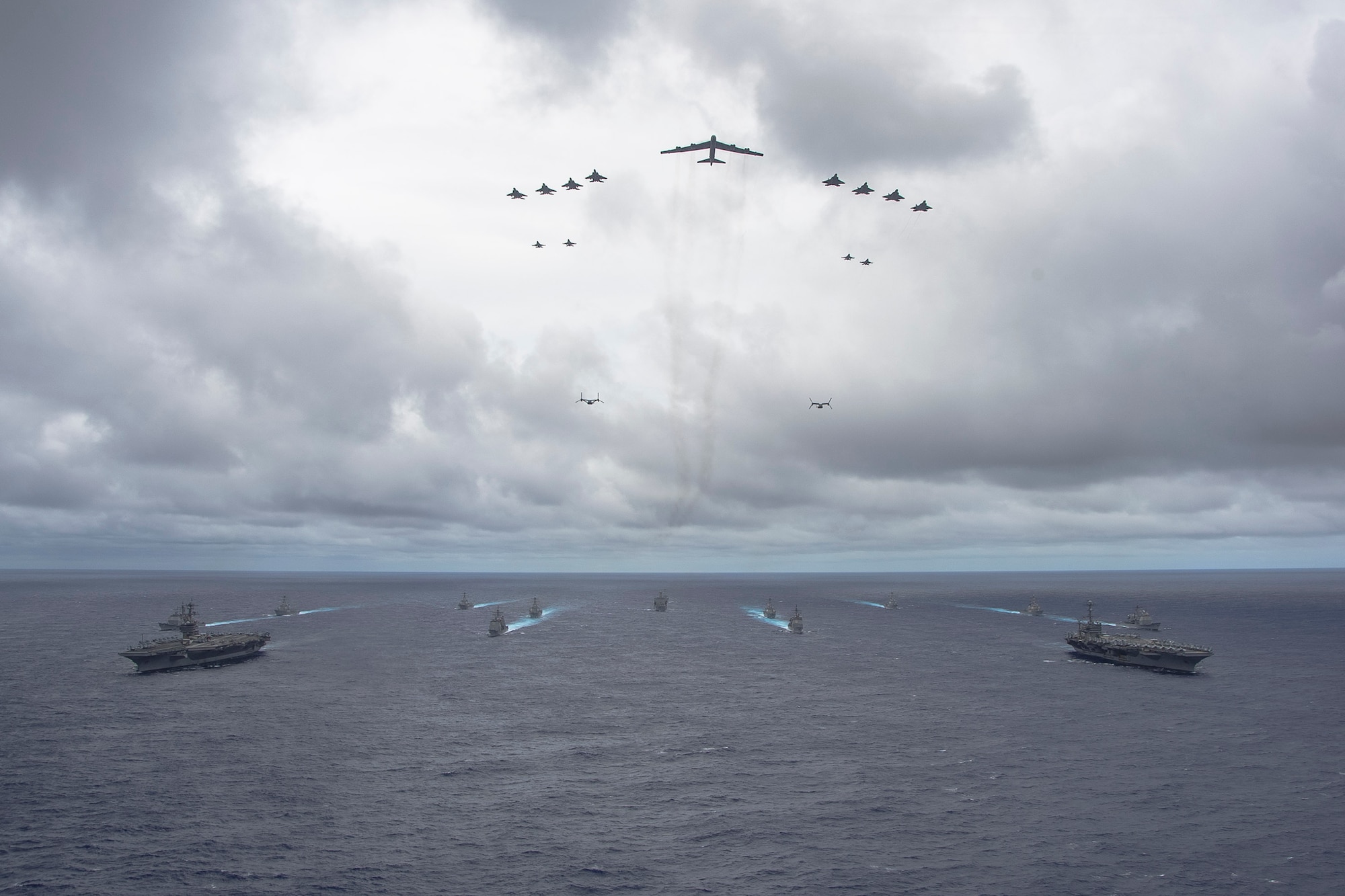 U.S. Navy ships from the George Washington and Carl Vinson Carrier Strike Groups and U.S. Air Force and Marine Corps aircraft operate in formation at the conclusion of Exercise Valiant Shield 2014, Sept. 23. Exercises like VS 14 provide the U.S. military the opportunity to integrate joint assets in an Air-Sea Battle environment, refining the military’s ability to defend U.S. interests and those of its allies and partners in the Pacific region. (U.S. Navy photo by Mass Communication Specialist 1st Class Trevor Welsh/Released)