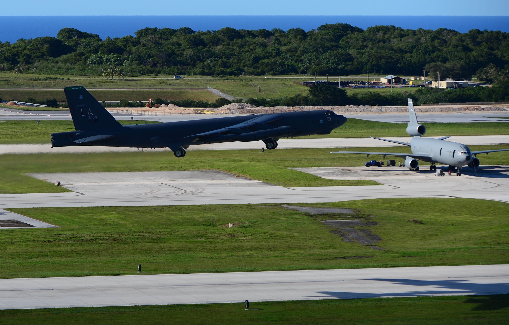 A B-52H Stratofortress from Barksdale Air Force Base, La., lifts off from an Andersen AFB, Guam runway while a KC-10 Extender is parked on the ramp, Sept. 18, 2014. Several B-52 crews and other 8th Air Force personnel participated in Exercise Valiant Shield, Sept. 15-23 – a biennial U.S. joint-forces training exercise in the Pacific region – while deployed to Andersen as part of the continuous bomber presence there. (U.S. Marine Corps photo by Lance Cpl. Abbey Perria/Released)