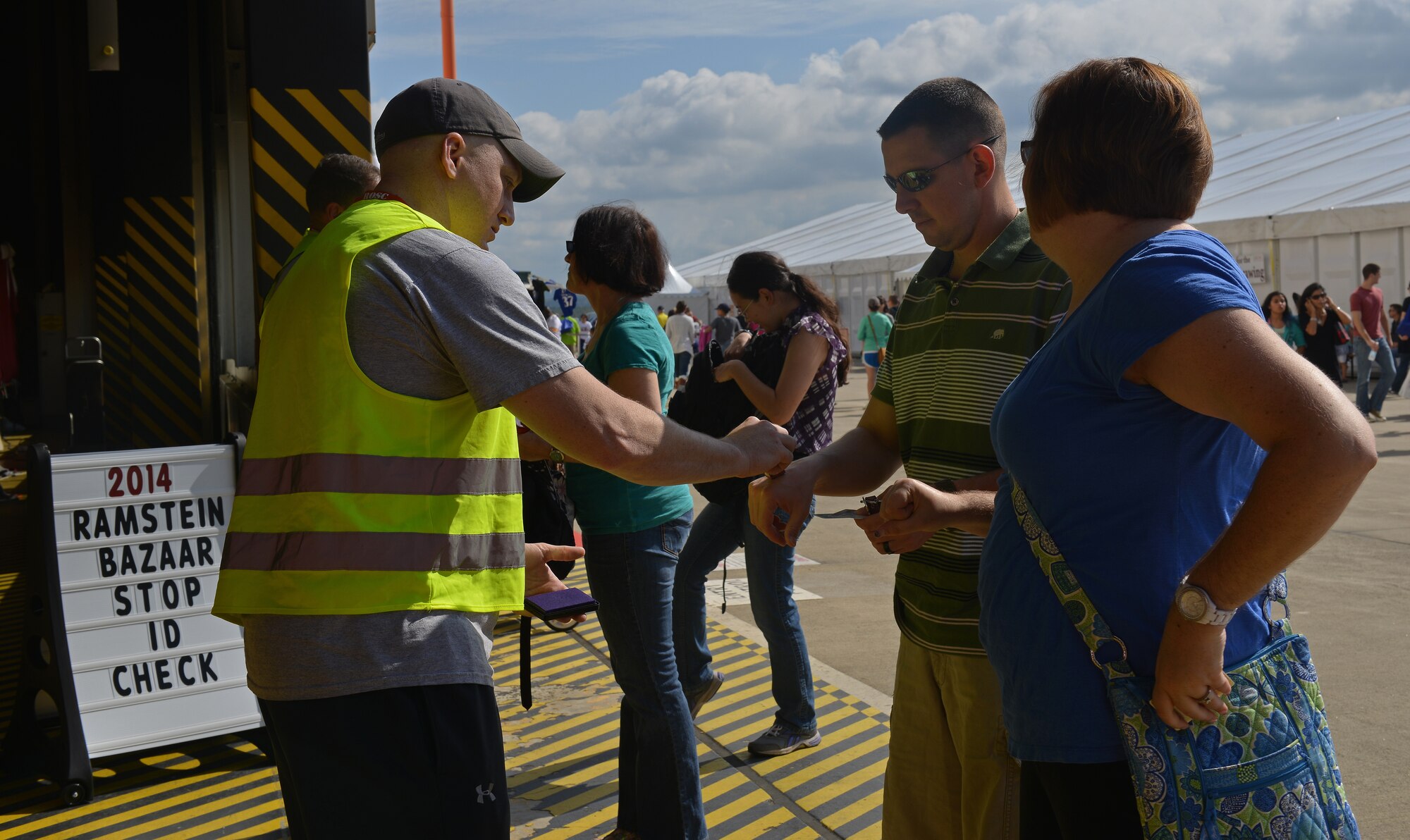 Tech. Sgt. Michael Broderick, 86th Security Forces Squadron program manager of local-national screening, volunteers as an identification card checker at the Ramstein Welfare Bazaar on Ramstein Air Base, Germany, Sept. 20, 2014. Volunteers helped setup and tear down different items, perform security and complete identification checks before, during and after the bazaar. (U.S. Air Force photo/Senior Airman Holly Mansfield)