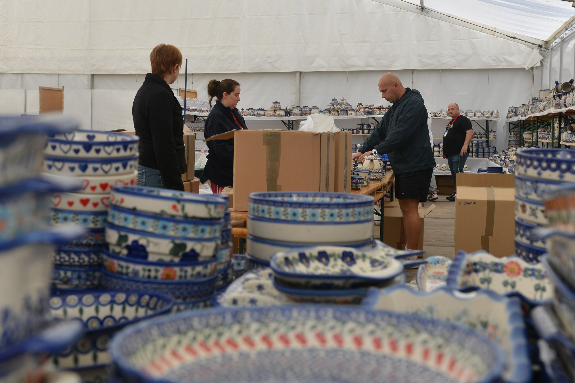 Ramstein Welfare Bazaar volunteers set out Polish pottery at Ramstein Air Base, Germany, Sept. 20, 2014. The bazaar celebrated its 50th anniversary by hosting more than 28,000 patrons from around the Kaiserslautern Military Community and more than 160 vendors from around Europe. (U.S. Air Force photo/Senior Airman Holly Mansfield)