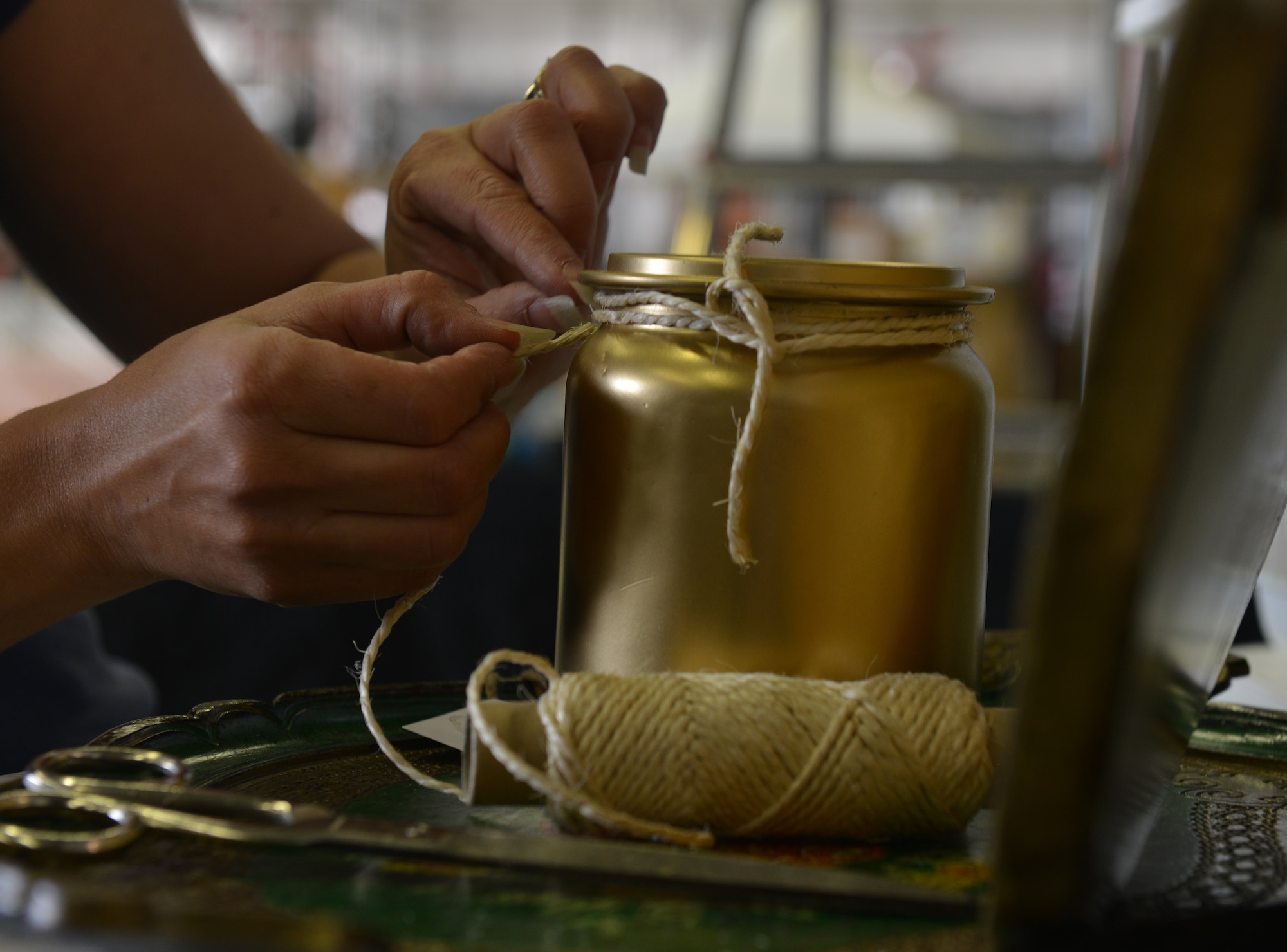 Andrea Noggle, vendor at the Ramstein Welfare Bazaar, prepares French painted vintage items before the start of the event on Ramstein Air Base, Germany, Sept. 20, 2014. Items varying from hand-made wooden clocks to Polish pottery were sold to more than 28,000 patrons over the span of the four-day 50th anniversary event. (U.S. Air Force photo/Senior Airman Holly Mansfield)