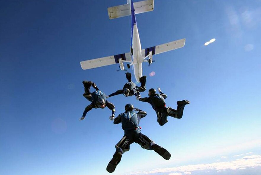 Parachutists jump from an aircraft flown by the 70th Flight Training Squadron at the Air Force Academy, Colorado.