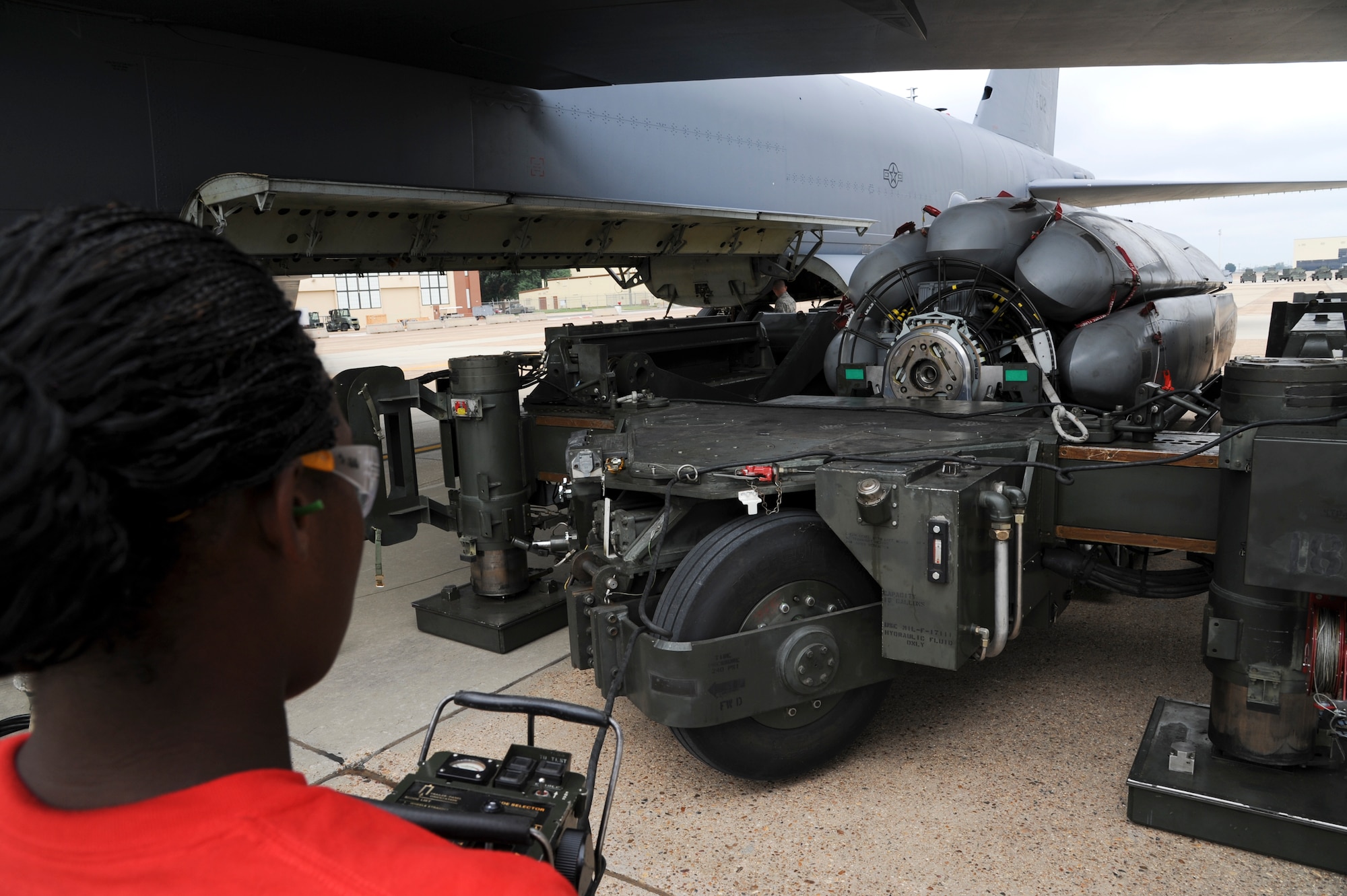 Senior Airman Breyana Anderson, 96th Aircraft Maintenance Unit weapons loader, guides a common strategic rotary launcher under the bomb bay of a B-52H Stratofortress during a weapons load competition on Barksdale Air Force Base, La., Sept. 19, 2014. The weapon load was part of a competition between load crews from the 96th and 20th AMU. (U.S. Air Force photo/Senior Airman Jannelle Dickey) 