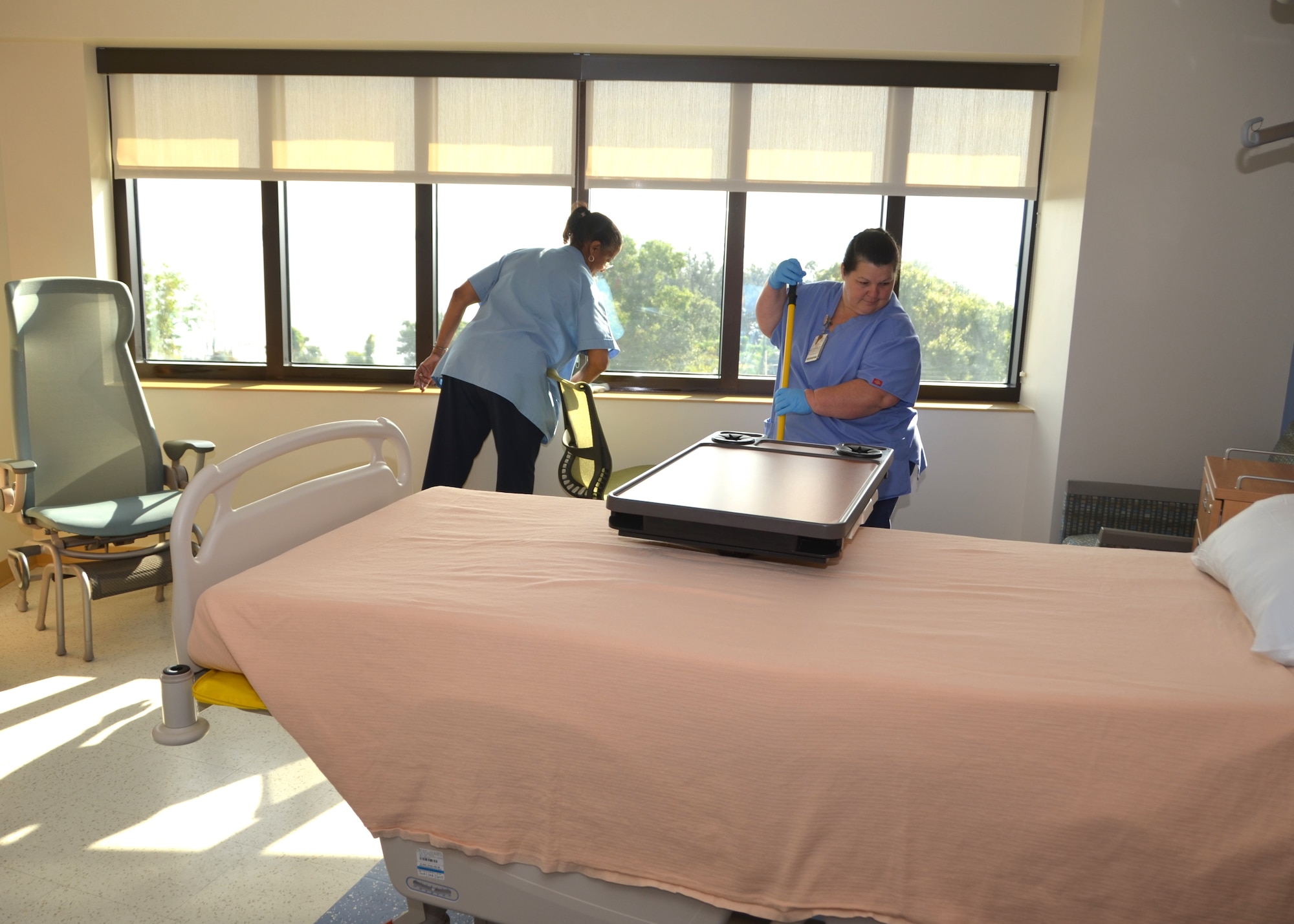 Keesler Medical Center housekeepers Judy Dickerson, left, and Theresa Migues prepare a room on the Surgical Inpatient Unit for a new patient Sept. 18.  The medical center housekeepers joined their counterparts nationwide Sept.14-20 to observe “National Housekeeper Appreciation Week.” (U.S. Air Force photo by Steve Pivnick)