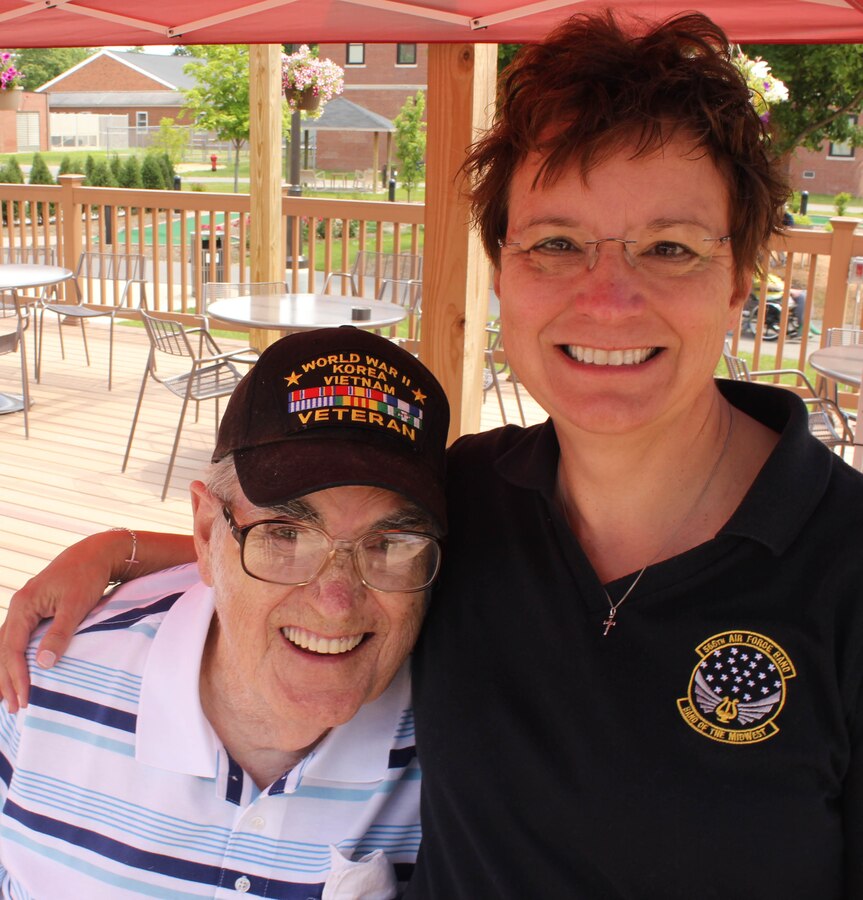 U.S. Air Force Master Sgt. Dorothy H. Detorres, instrumentalist with the 566th Air Force Band, visits with a veteran during Air National Guard Band of the Midwest's annual training at the Tomah VA Medical Center Home, Tomah, Wisc., July 5, 2014. They performed jazz, rock and concert music for audiences in Illinois and Wisconsin as part of their community relations tour before a grand finale in Minnesota July 4. The annual concert series was the result of a year’s worth of training and practice, one that the band used to celebrate patriotism with communities across the Midwest. (Courtesy photo/Released)