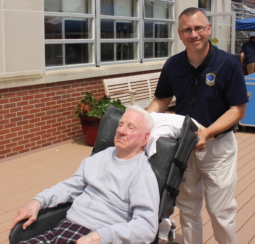 U.S. Air Force Master Sgt. James D. Barnard, instrumentalist with the 566th Air Force Band, visits with a veteran during the  Air National Guard Band of the Midwest's annual training at the Tomah VA Medical Center Home, Tomah, Wisc., July 5, 2014. They performed jazz, rock and concert music for audiences in Illinois and Wisconsin as part of their community relations tour before a grand finale in Minnesota July 4. The annual concert series was the result of a year’s worth of training and practice, one that the band used to celebrate patriotism with communities across the Midwest. (Courtesy photo/Released)