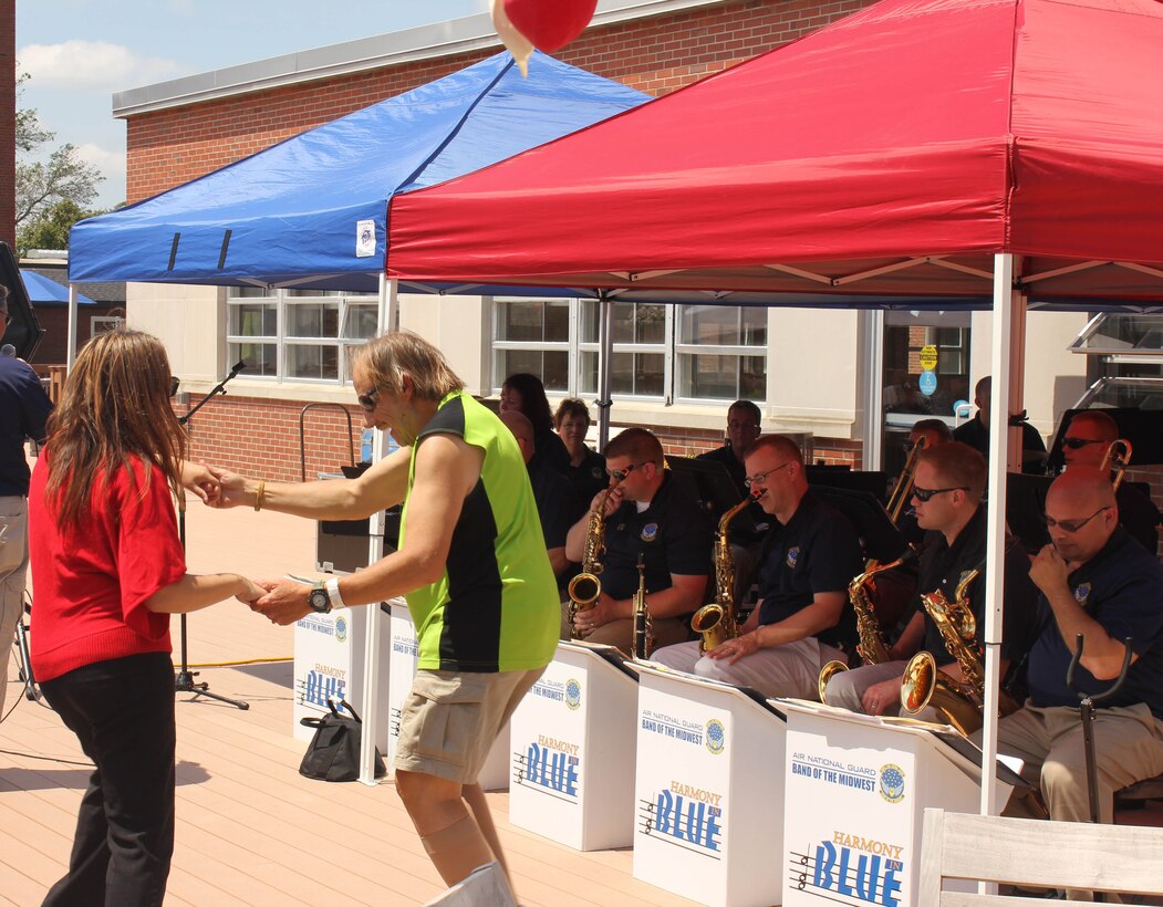 Audience members dance during the Air National Guard Band of the Midwest's annual training at the Tomah VA Medical Center Home, Tomah, Wisc., July 5, 2014. They performed jazz, rock and concert music for audiences in Illinois and Wisconsin as part of their community relations tour before a grand finale in Minnesota July 4. The annual concert series was the result of a year’s worth of training and practice, one that the band used to celebrate patriotism with communities across the Midwest. (Courtesy photo/Released)