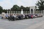 World War II veterans gather for a group photo at the World War II Memorial in Washington, D.C., Sept. 19, 2014. Family members standing amongst veterans also held portraits of recently passed veterans. The veterans were part of a group of 66 that were there to see their memorial, many for the first time.(U.S. Air Force photo by Senior Master Sgt. Gary J. Rihn/Released)