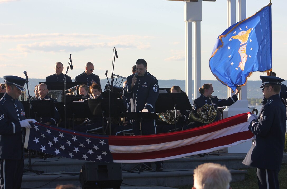 From left, U.S. Air Force Staff Sgt. Scott A. Parsons and Senior Airman Devin P. Larue, both instrumentalists with the 566th Air Force Band, conduct a flag-folding ceremony as the Air National Guard Band of the Midwest performs for audiences during annual training at Barker’s Island Festival Park, Superior, Wis., July 3, 2014. They performed jazz, rock and concert music for audiences in Illinois and Wisconsin as part of their community relations tour before a grand finale in Minnesota July 4. The annual concert series was the result of a year’s worth of training and practice, one that the band used to celebrate patriotism with communities across the Midwest. (Courtesy photo/Released)