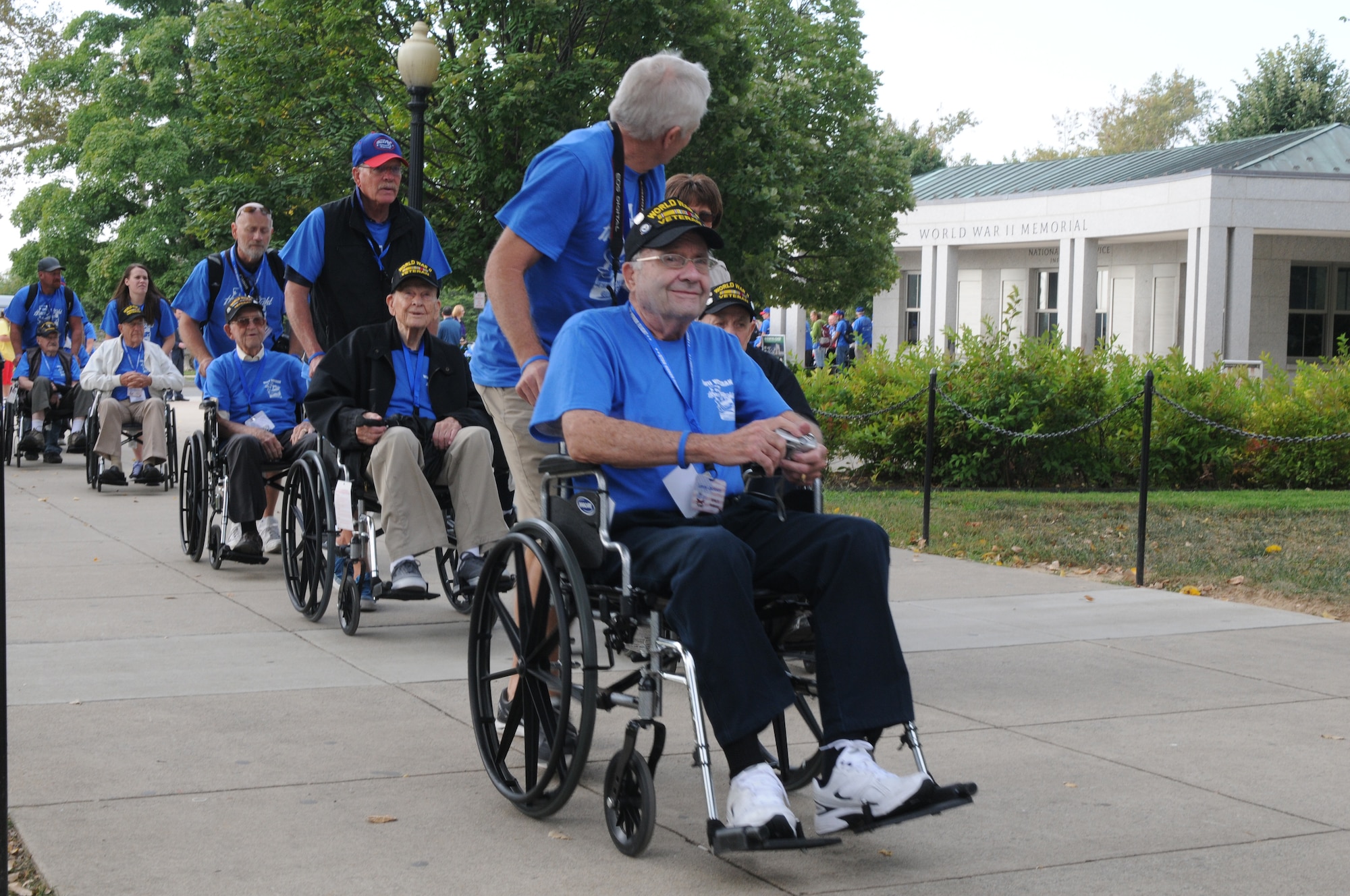 World War II veterans are escorted into the the World War II Memorial in Washington, D.C., Sept. 19, 2014. The group consisted of 66 veterans that made the journey from Utah to see their memorial, many for the first time.(U.S. Air Force photo by Senior Master Sgt. Gary J. Rihn/Released)