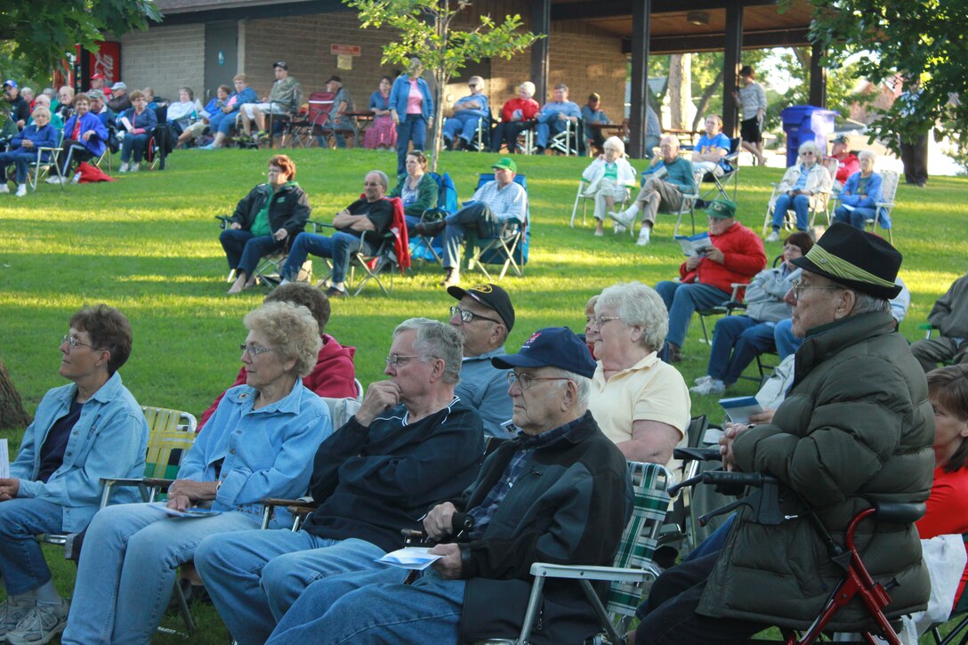 Audience members watch as the Air National Guard Band of the Midwest performs during annual training at the City Park Band Shell, Rice Lake, Wis., July 2, 2014. They performed jazz, rock and concert music for audiences in Illinois and Wisconsin as part of their community relations tour before a grand finale in Minnesota July 4. The annual concert series was the result of a year’s worth of training and practice, one that the band used to celebrate patriotism with communities across the Midwest. (Courtesy photo/Released)