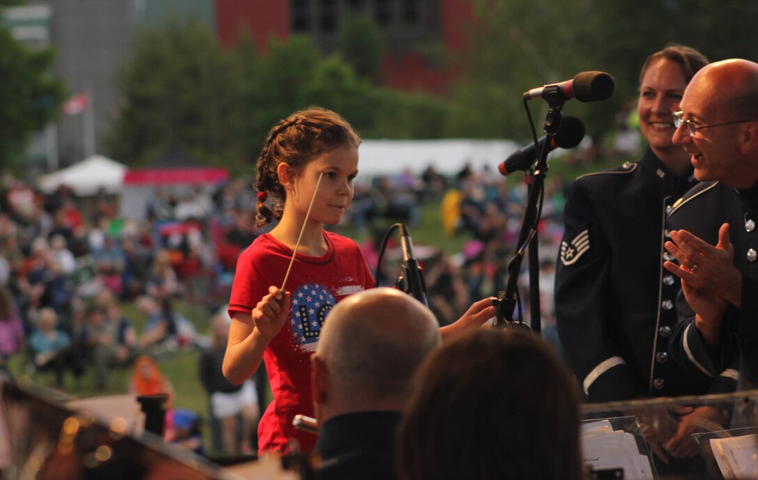 Audience members watch as the Air National Guard Band of the Midwest perform for audiences during annual training at the Grundy County Courtyard Lawn, Morris, Ill., June 29, 2014. They performed jazz, rock and concert music for audiences in Illinois and Wisconsin as part of their community relations tour before a grand finale in Minnesota July 4. The annual concert series was the result of a year’s worth of training and practice, one that the band used to celebrate patriotism with communities across the Midwest. (Courtesy photo/Released)
